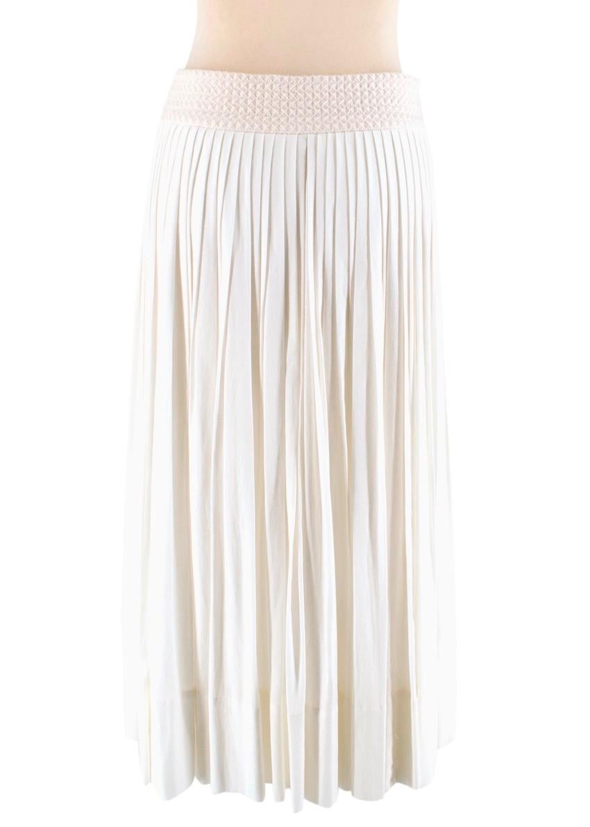 Hermes ivory pleated cotton midi skirt 

- loose fit - single vent at each side - two open slip side pockets - contrasting woven wool waistband with button fastenings on either side

- made in France - dry clean only

Please note, these items are