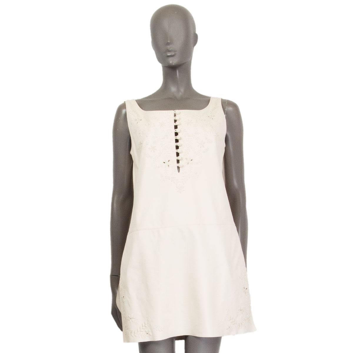 100% authentic Hermes sleeveless shift dress in ivory lambskin (100%) with a seam-cut at the waist-line and floral embellishment  on the chest and at the sides hem. Closes with buttons at the front and has slits on the sides. Lined in ivory silk