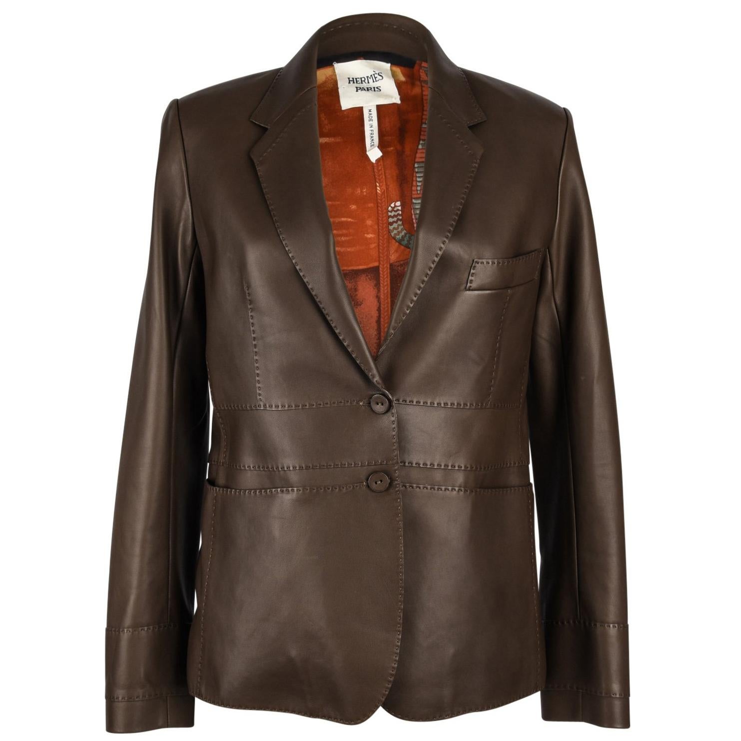 Guaranteed authentic Hermes single breast brown lambskin leather jacket. 
Exquisitely tailored in the softest lambskin accented with top stitch detail throughout and 2 covered buttons.
Jacket has 1 breast pocket and 2 slot pockets.
Lined in a