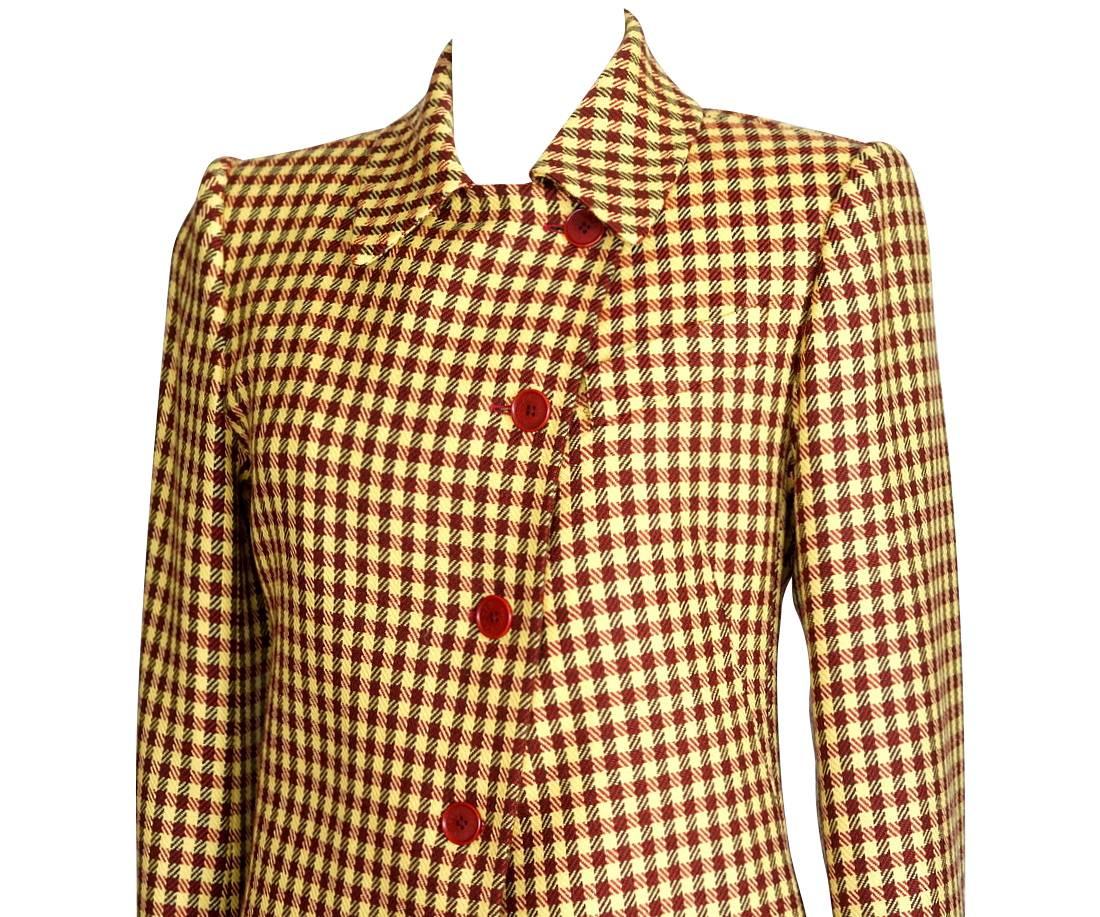 Guaranteed authentic Hermes wool and cashmere soft plaid jacket.        
Single breast with asymmetrical buttons and 1 slot breast pocket.
Striking brown and rust plaid on a yellow background.
4 front brick logo embossed buttons, and 3 on each