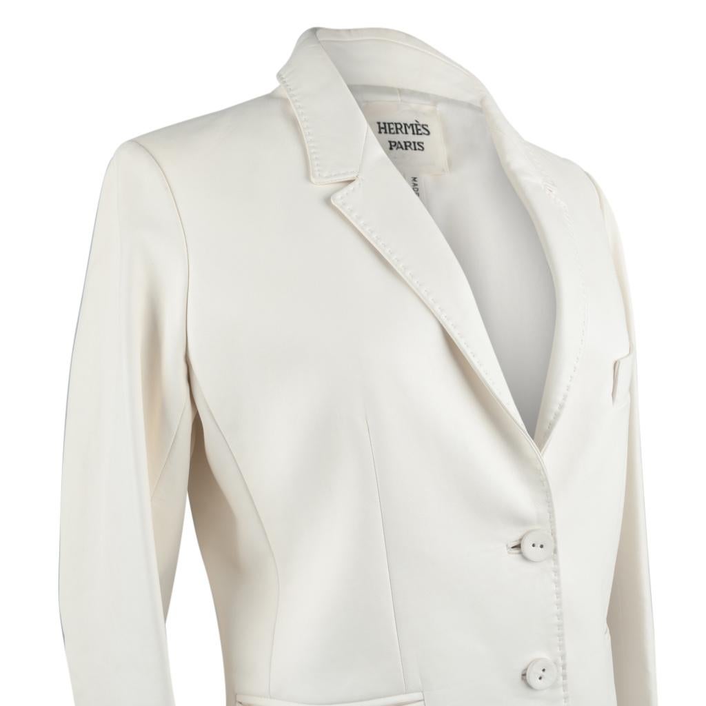 Guaranteed authentic Hermes two button single breast winter white lambskin leather jacket. 
Exquisitely tailored in the softest lambskin accented with top stitch detail.
Cuffs have two buttons.  All buttons are white.
Jacket has one breast pocket