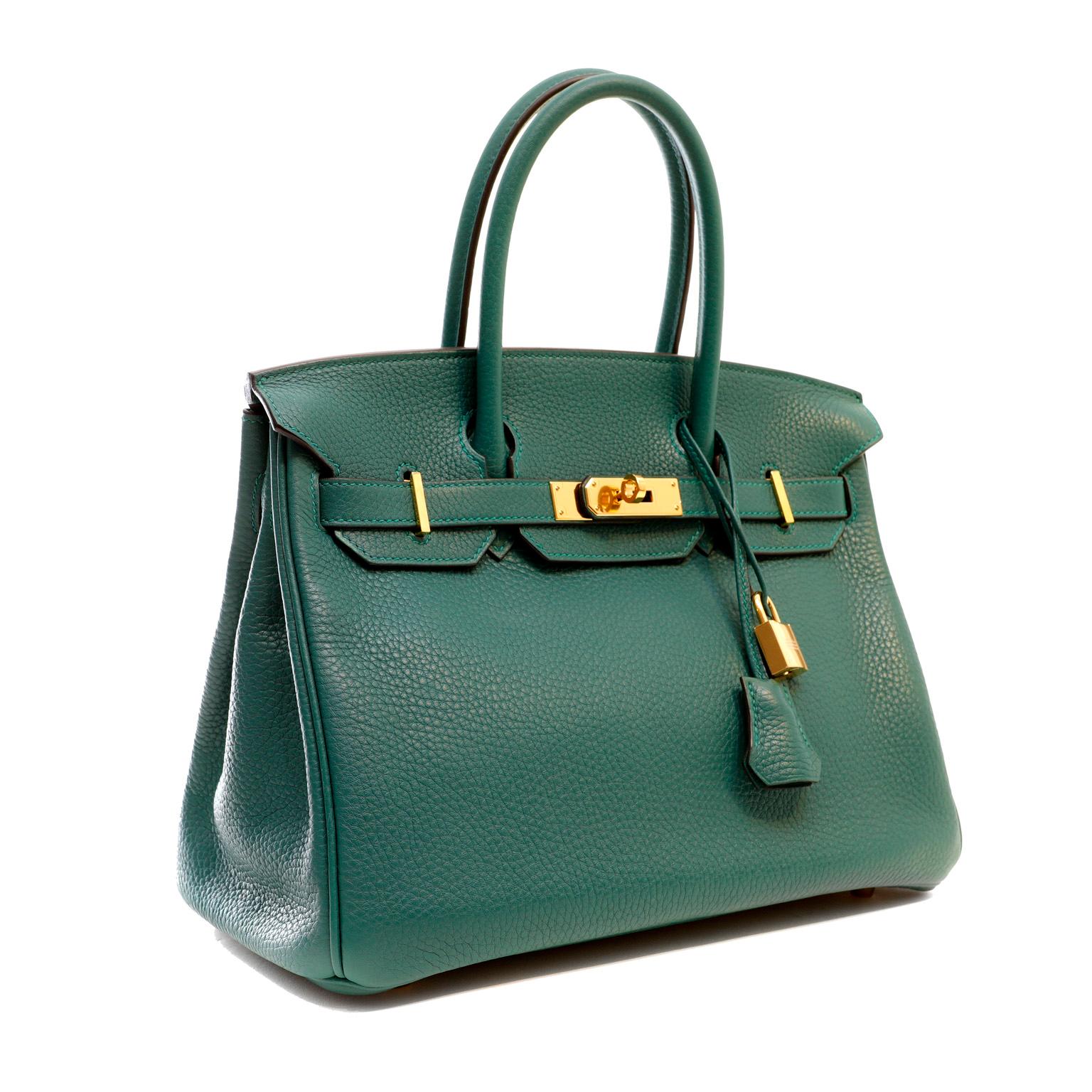 This authentic Hermès Jade Green Togo 30 cm Birkin is in pristine unwormn condition with the protective plastic intact on the hardware.  Hand stitched by skilled craftsmen, wait lists of a year or more are commonplace for the Hermès Birkin. Jewel