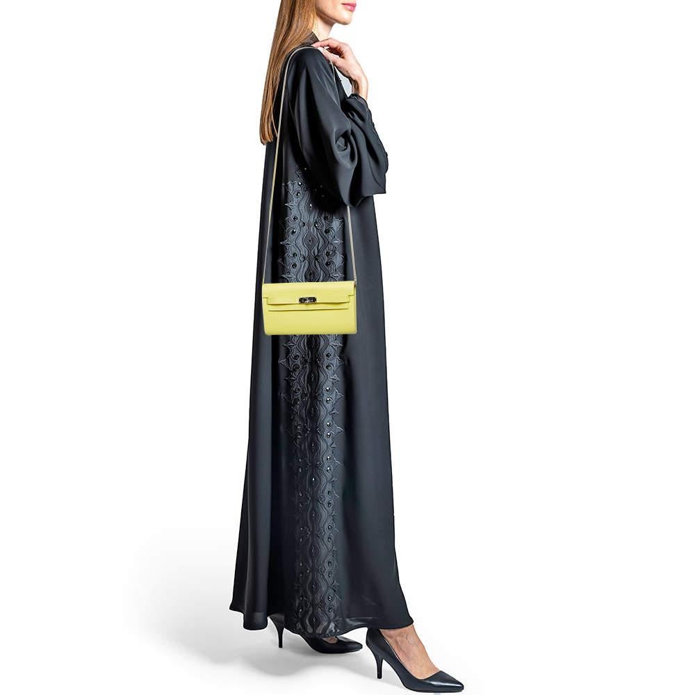 Le portefeuille Kelly To Go d'HermÃ¨s allie style iconique et élégance pratique. Fabriqué en cuir Evercolor luxueux dans une teinte jaune vibrante  Il est doté de la fermeture classique Kelly à verrou tournant. Avec des fentes et des compartiments