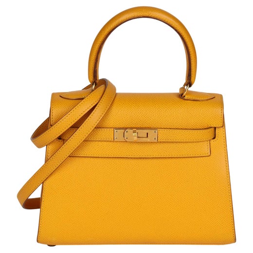 This stunning Hermès Kelly 28cm bag is featured in Jaune Ambre color. This  bag is made from Epsom leather, which is very sof…
