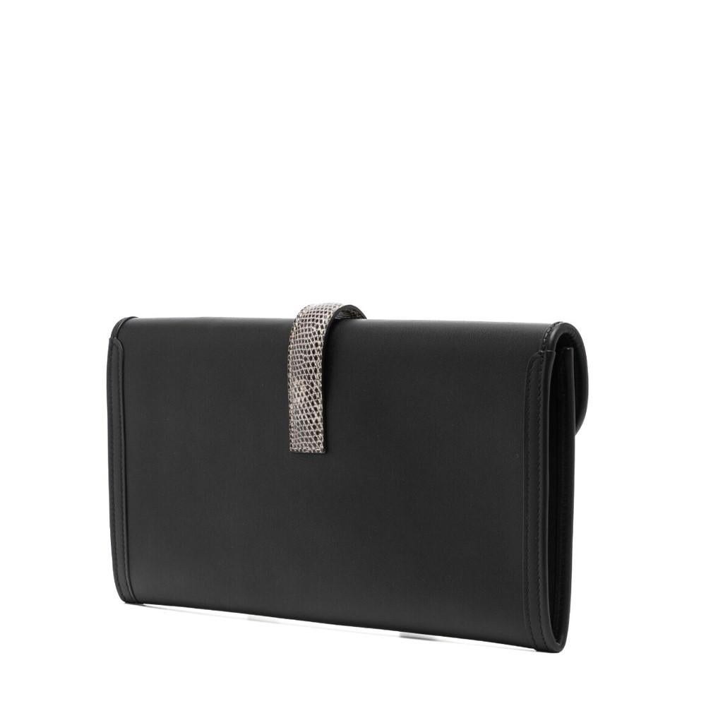 This black clutch from Hermès, crafted from calf leather and detailed with leather accents, is a timeless classic. It features the signature H logo, a front flap closure, a main compartment, and an internal logo stamp. A sophisticated addition to
