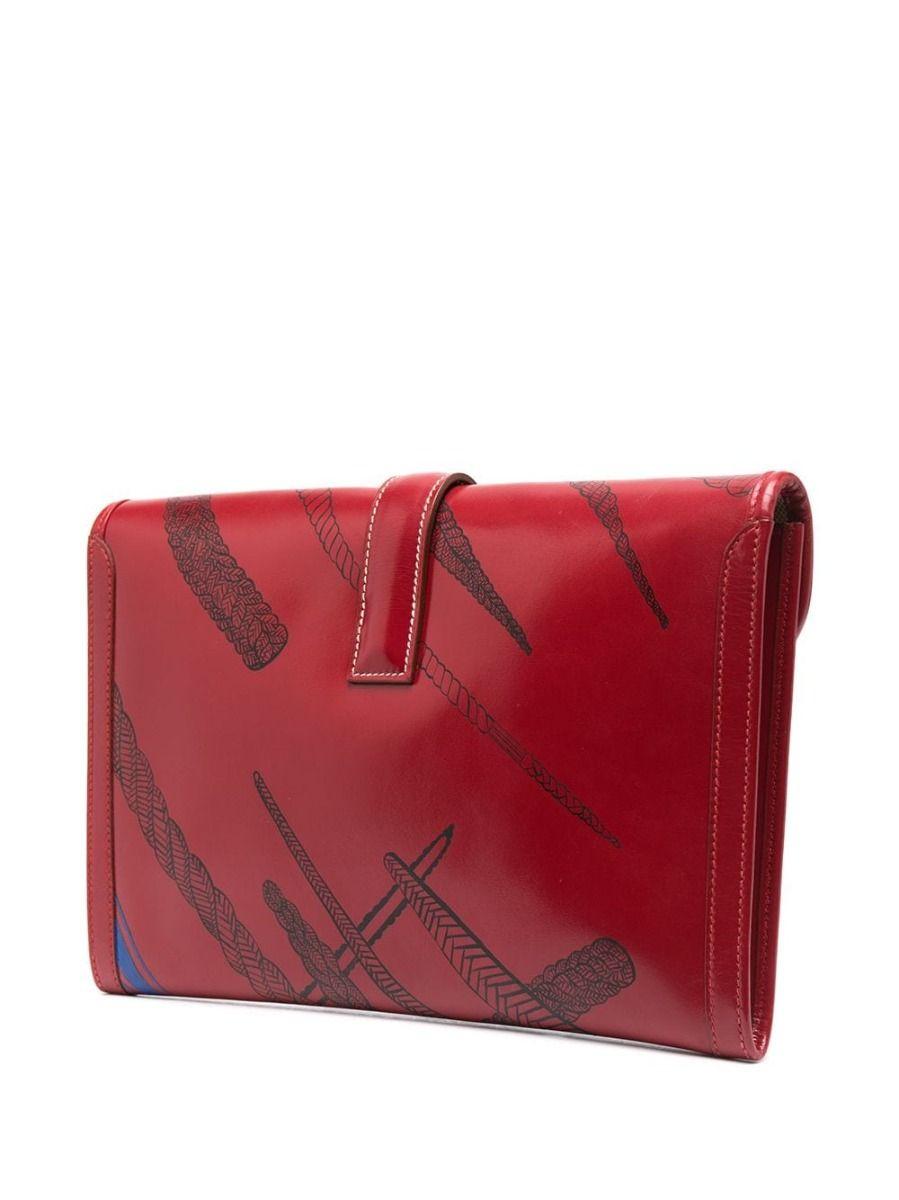 This Hermes red leather Jige clutch is like no other, customised with handpainted knot print all over the front and back of the iconic clutch. The equestrian-inspired print complements the Hermes style and history of the brand, making this Jige