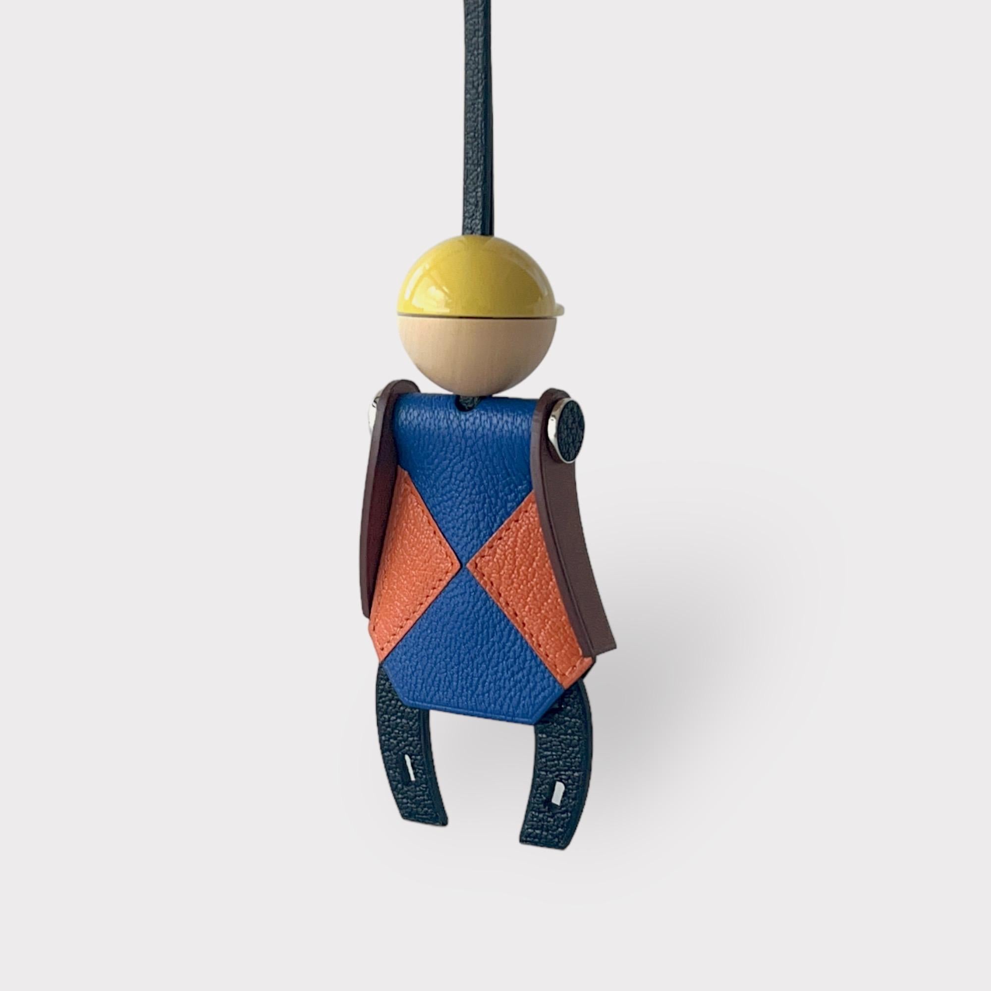 The Hermes Hermès Jockey Charm In Mysore Leather is a new charm for 2023. It is made primarily from Mysore goatskin and Calfskin. It features a lacquered wooden helmet and palladium plated shoulders. It is the perfect addition to any bag, adding a