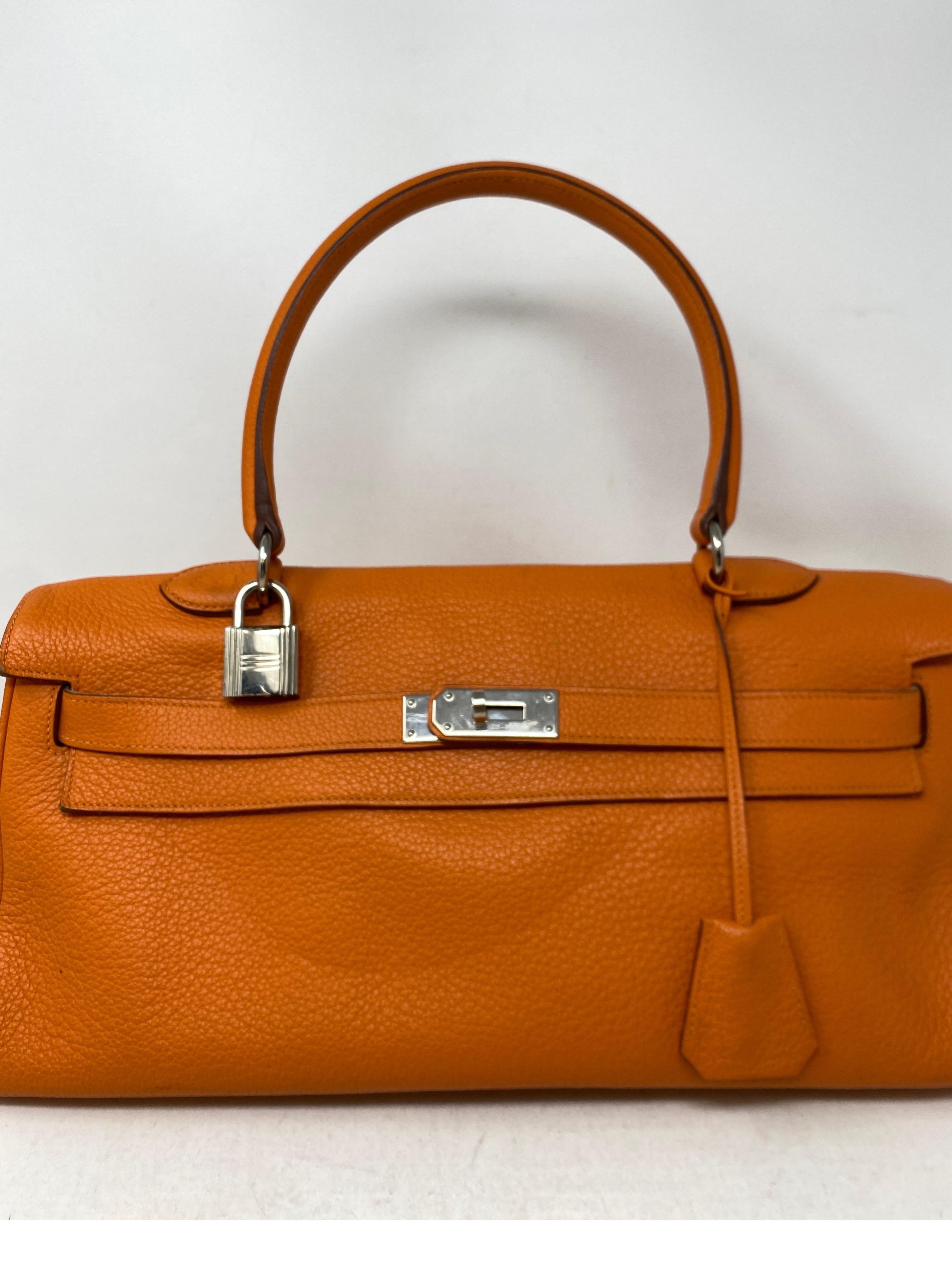 Hermes JPG Orange Bag. Rare unique looking size Hermes bag. Shoulder bag with palladium hardware. Good condition. Some wear on leather. Please see photos. Light corner scuff. Slight indention in the front. Classic Hermes orange color. Interior