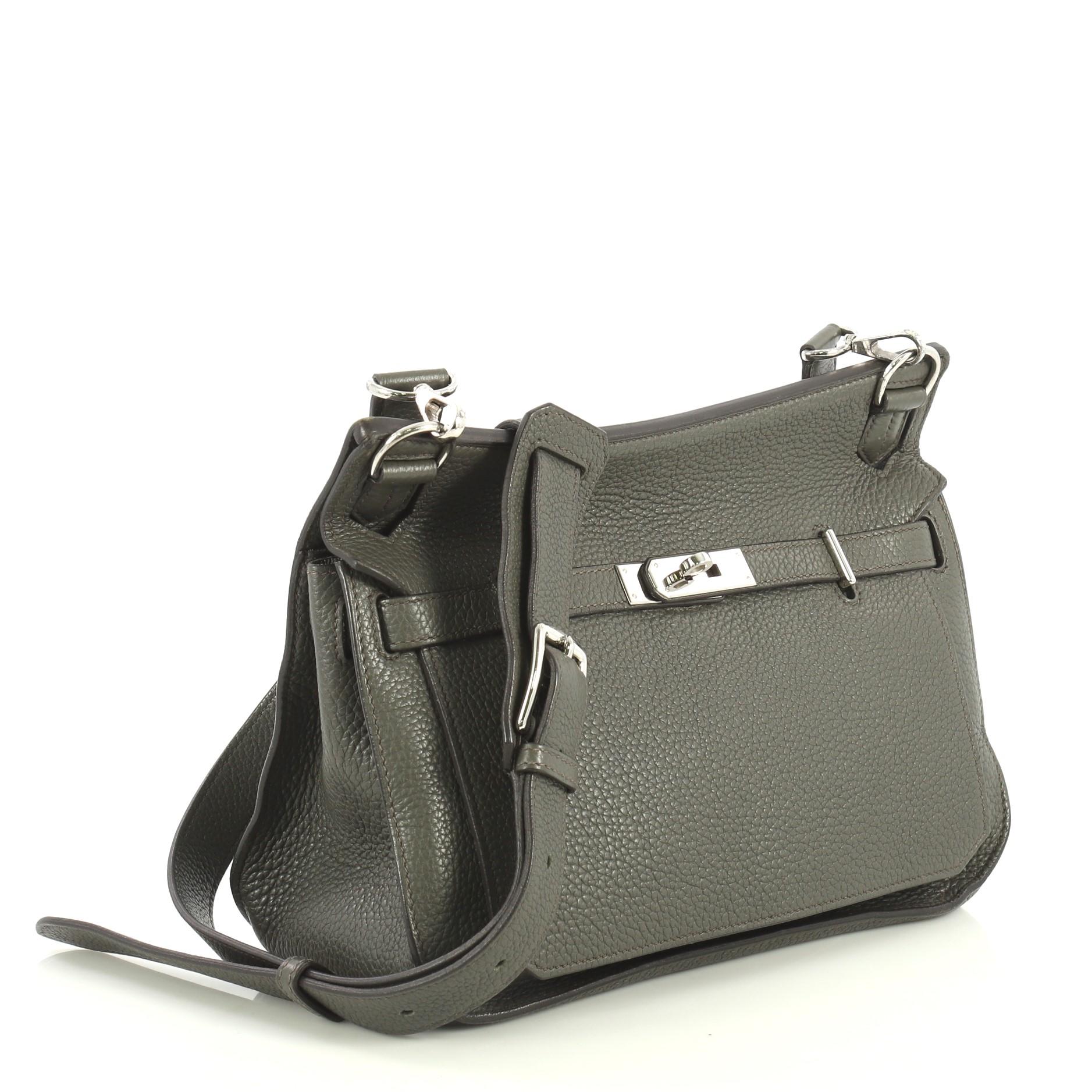 This Hermes Jypsiere Handbag Clemence 28, crafted in Vert de Gris green Clemence leather, features a long adjustable strap and palladium hardware. Its front flap with the turn-lock closure opens to a Vert de Gris green Chevre leather interior with