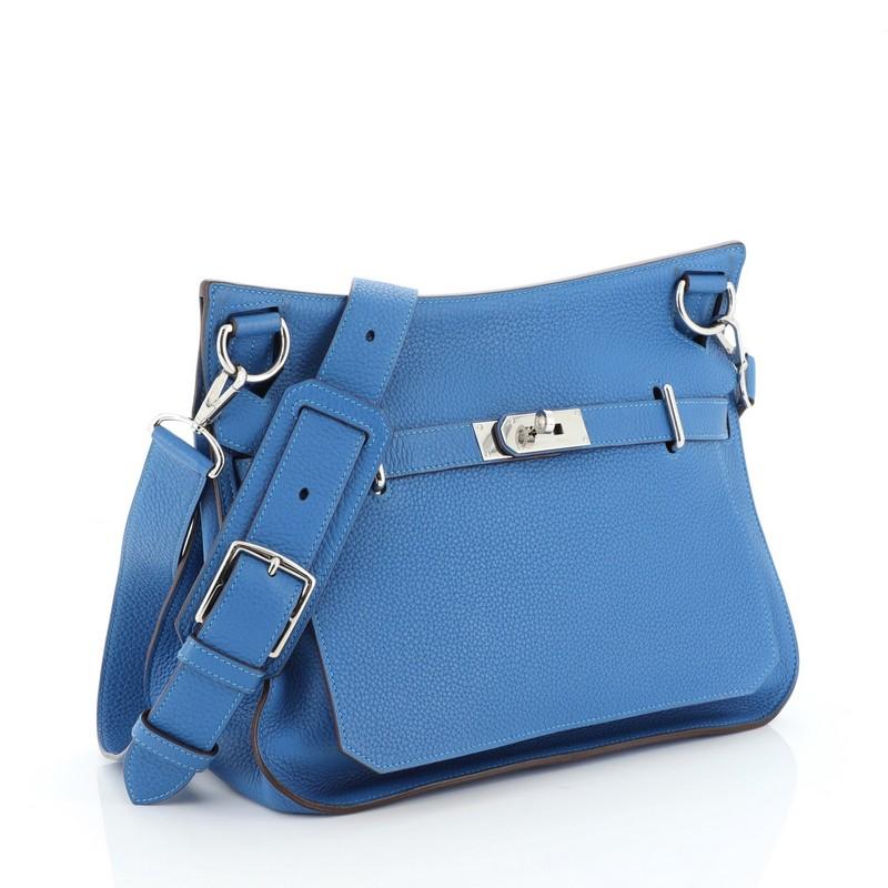 This Hermes Jypsiere Handbag Clemence 31, crafted from Mykonos blue Clemence leather, features a flat adjustable leather shoulder strap and palladium hardware. Its front flap with turn-lock clasp closure opens to a Mykonos blue Chevre leather