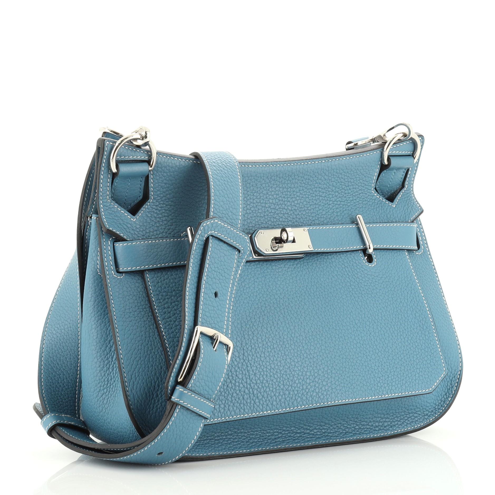 This Hermes Jypsiere Handbag Clemence 31, crafted from Bleu Jean blue Clemence leather, features a flat adjustable leather shoulder strap and palladium hardware. Its front flap with turn-lock clasp closure opens to a Bleu Jean blue Chevre leather