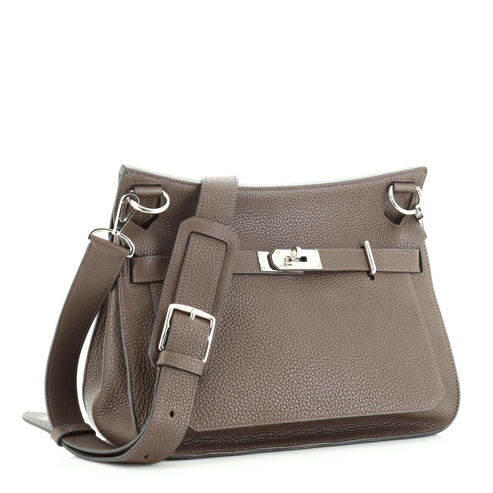 This Hermes Jypsiere Handbag Clemence 31, crafted from Chocolate brown Clemence leather, features a flat adjustable leather shoulder strap and palladium hardware. Its front flap with turn-lock clasp closure opens to a Chocolate brown Chevre leather