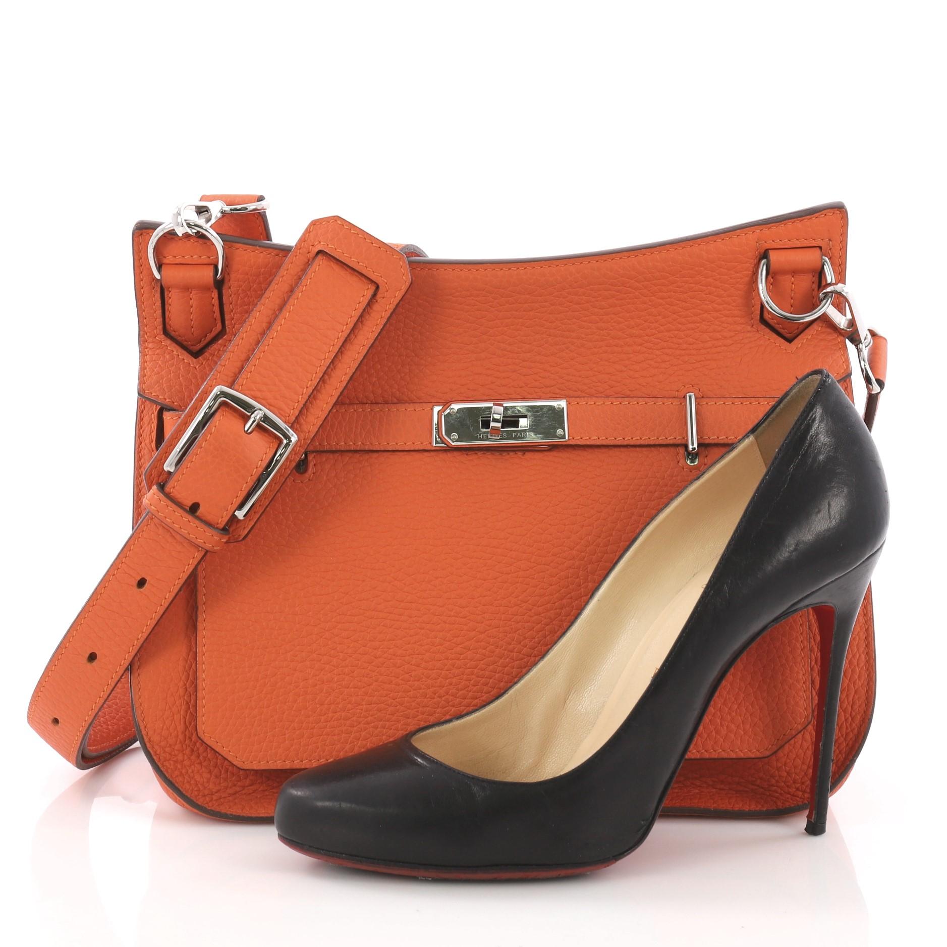 This Hermes Jypsiere Handbag Togo 28, crafted in orange togo leather, features long adjustable strap and palladium-tone hardware. Its turn-lock clasp closure opens to an orange leather interior with slip and zip pockets. Date stamp reads: R Square