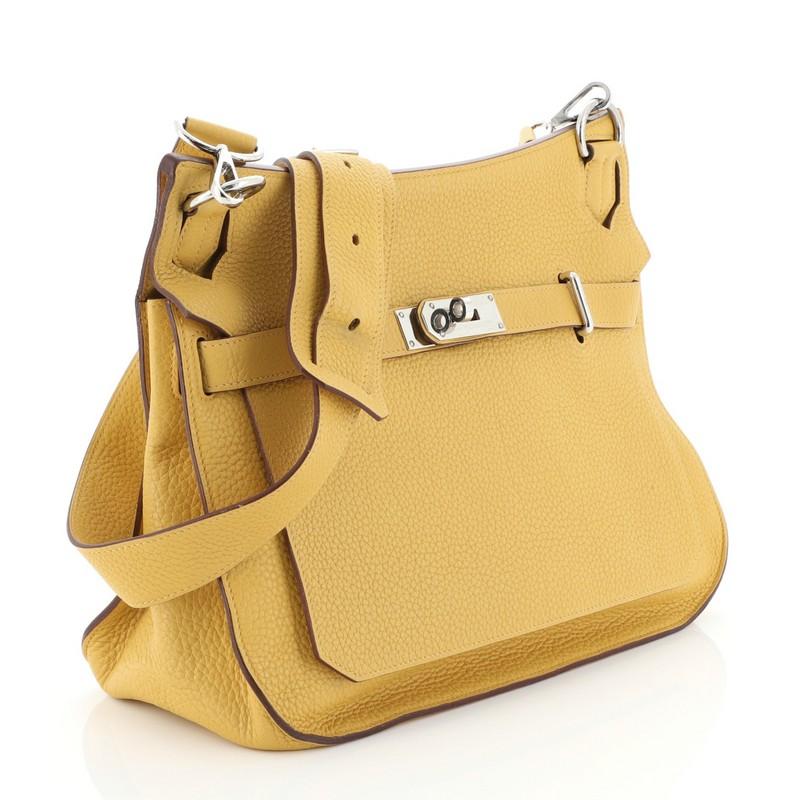 This Hermes Jypsiere Handbag Togo 34, crafted in yellow Togo leather, features a long adjustable strap and palladium hardware. Its front flap with turn-lock clasp closure opens to a yellow leather interior with slip and zip pockets. Date stamp