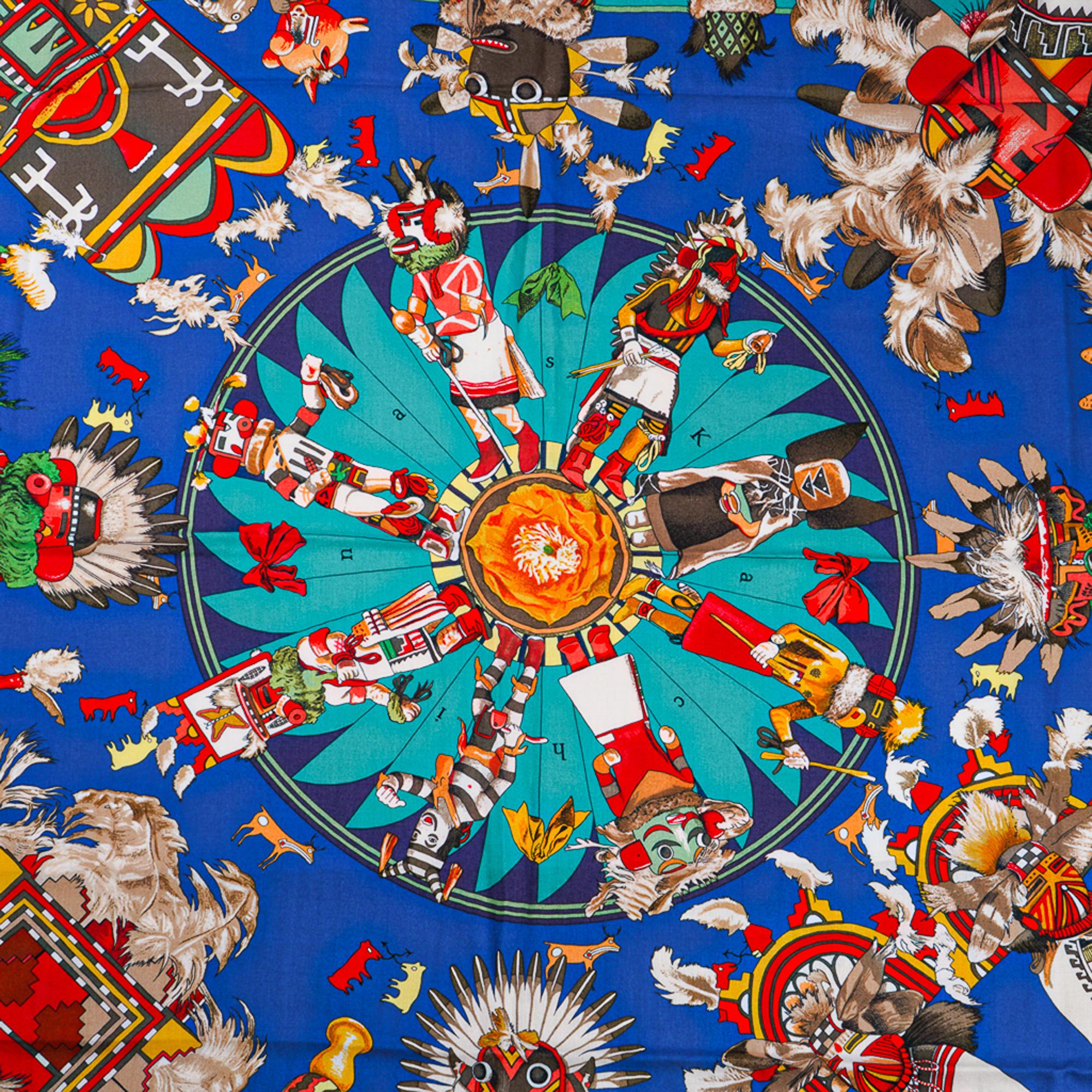 Mightychic offers a  guaranteed authentic Hermes Kachinas Cashmere and Silk scarf by Kermit Oliver.
Royal Blue, Red, Orange, Yellow, White colorway.
Depicts ritual dolls given to Hopi children.
With their peace loving nature, they are on good terms