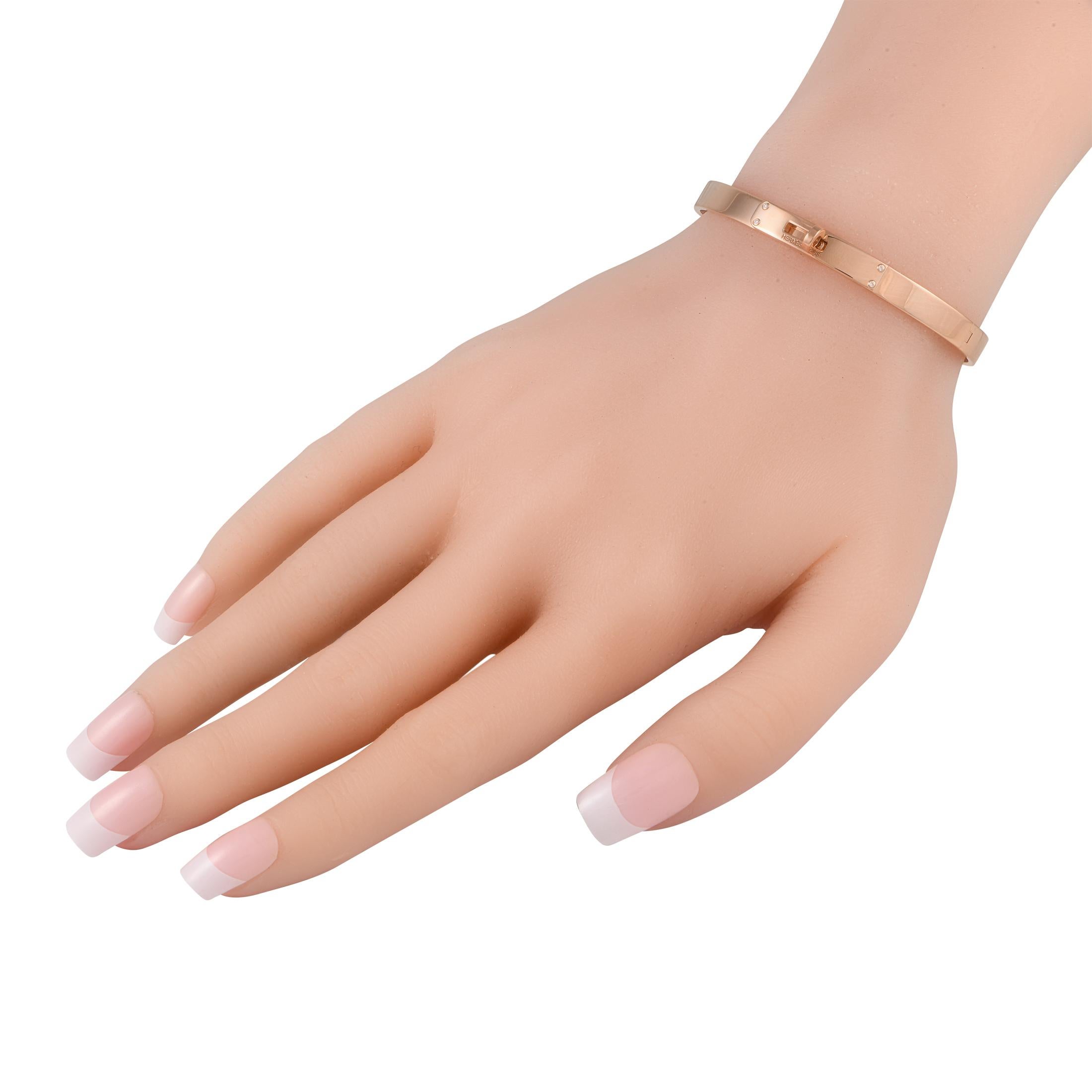 This impeccably crafted Hermes Kelly bracelet will add a touch of luxury to any ensemble. Shimmering 18K rose gold highlights the brands iconic turnlock design, which makes a statement at the center of this sleek bangle-style bracelet. It measures