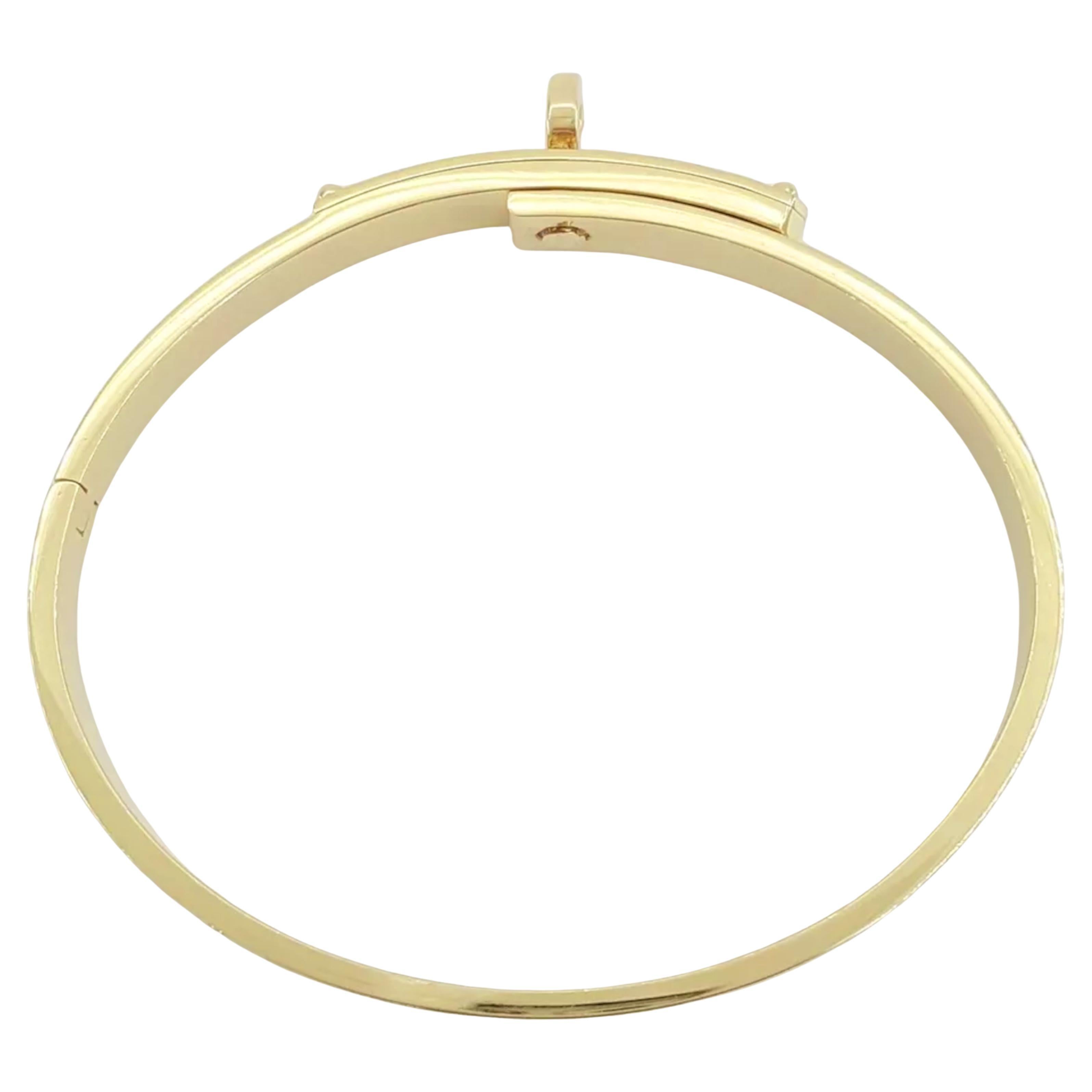 Hermès Kelly 18K Yellow Gold Pave Diamonds Bracelet

This exquisite bracelet is crafted from solid 18K Yellow Gold, weighing 21.5 grams and measuring 5.5 mm in width. It is a Size XS, with an inner diameter of 48.5 x 39 mm.

The bracelet features 61