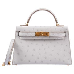 Hermès Kelly 20 Mini II Sellier Gris Perla Avestruz con Herrajes Dorados