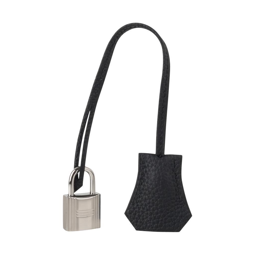 Guaranteed authentic Hermes Kelly 25 retourne bag is featured in classic Black togo leather.
Fresh with palladium hardware. 
Perfect to carry day to evening.  
Comes with signature Hermes box, raincoat, shoulder strap, sleepers, lock, keys and