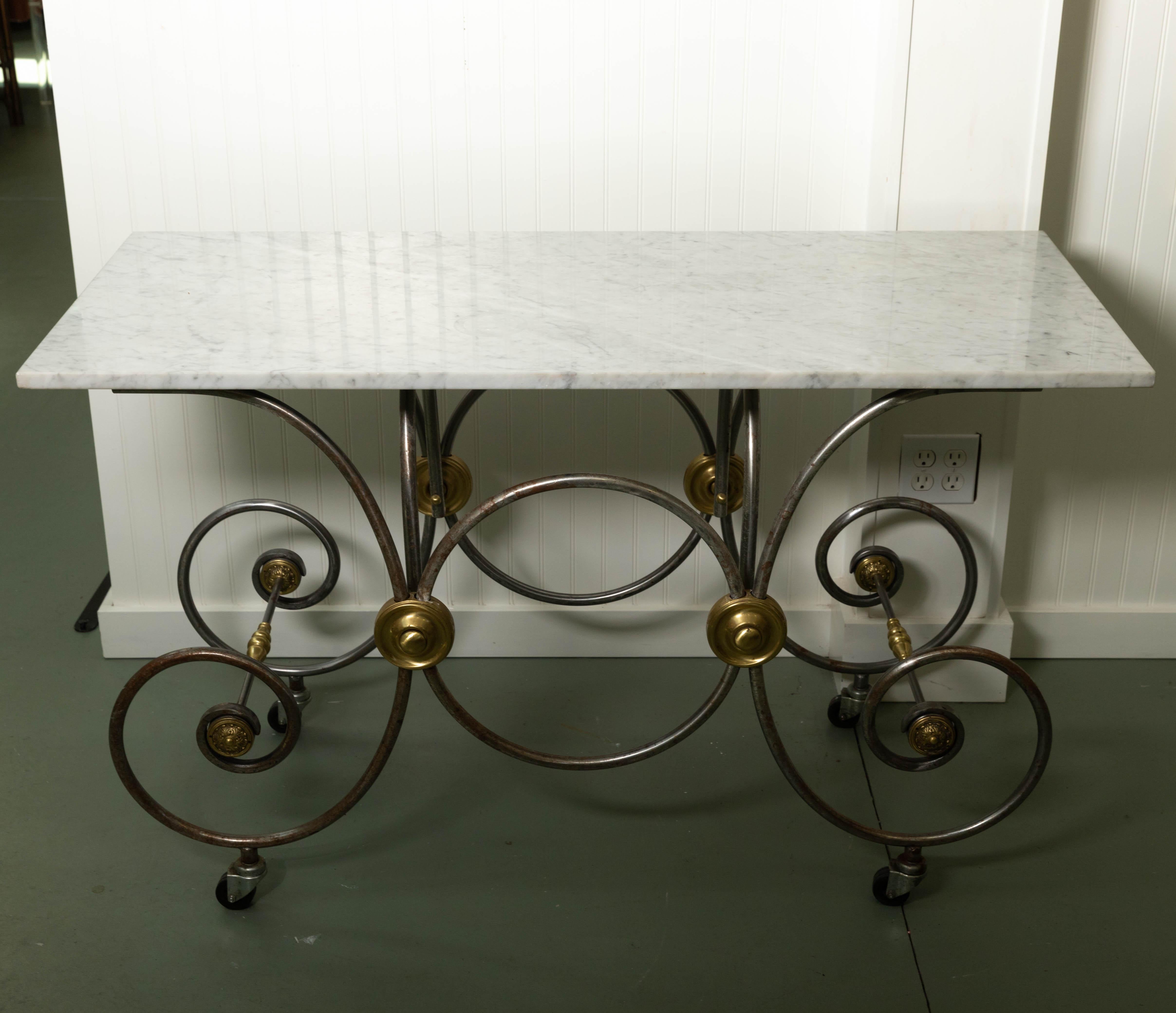 Bakers table, French style marble top, metal and brass base on wheels.