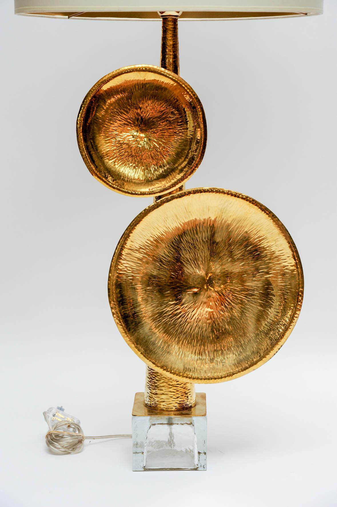 Pair of table lamps made of a square Murano foot, and hammered brass cone shaped body supporting two decorative plates.