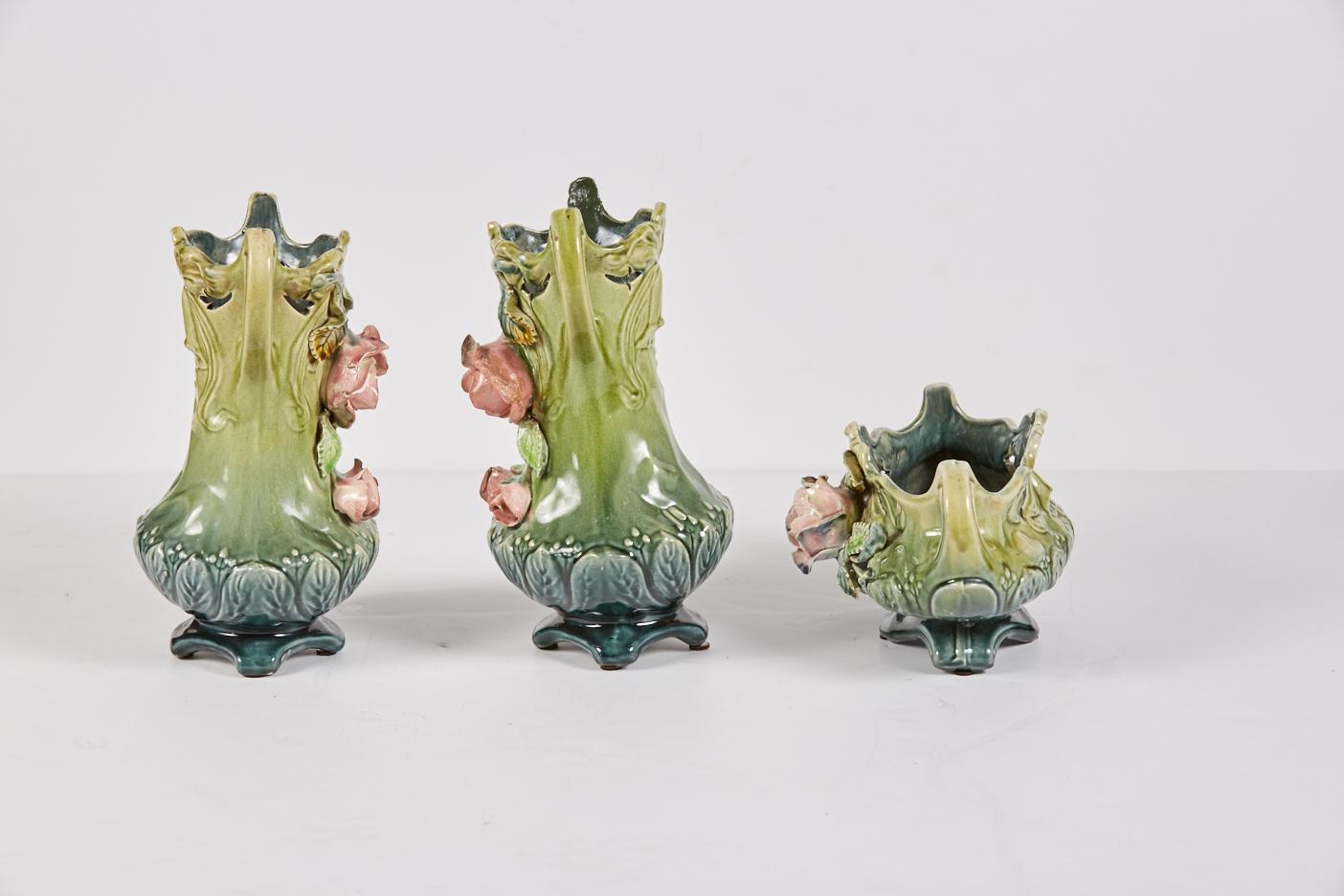 Antique French Barbotine garniture consisting of a pair of vases and a jardinière, each with applied roses. Vases measure 11.5