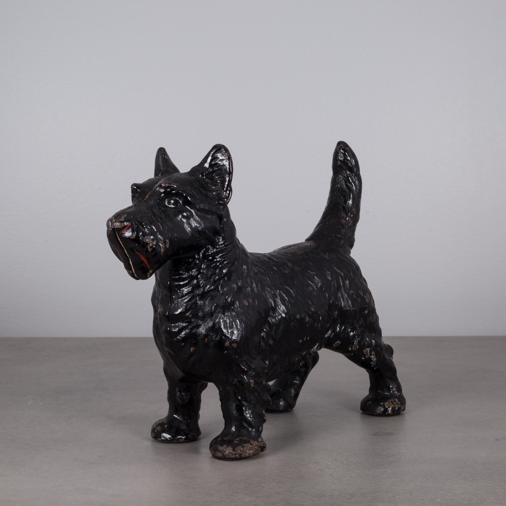 This is an original cast iron Scottish Terrier doorstop manufactured by the Hubley Manufacturing Company in Lancaster Pennsylvania USA. The piece has retained its original hand painted finish and is in excellent condition with the appropriate patina