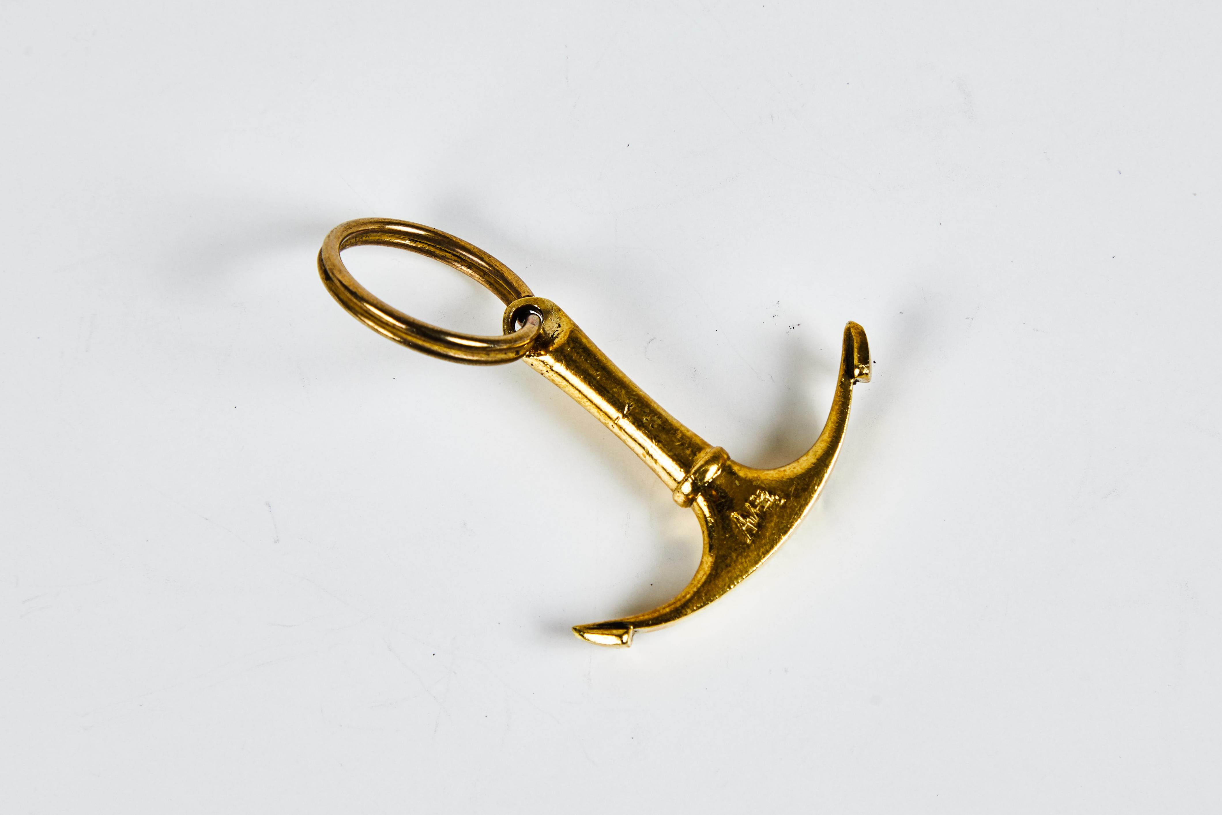 Carl Auböck Model #7151 brass figurine keyring. Designed in the 1950s, this incredibly refined and sculptural object is hand fabricated in polished brass. 

Price is per item. Other Aubock keyrings also available in separate listings. One pair in