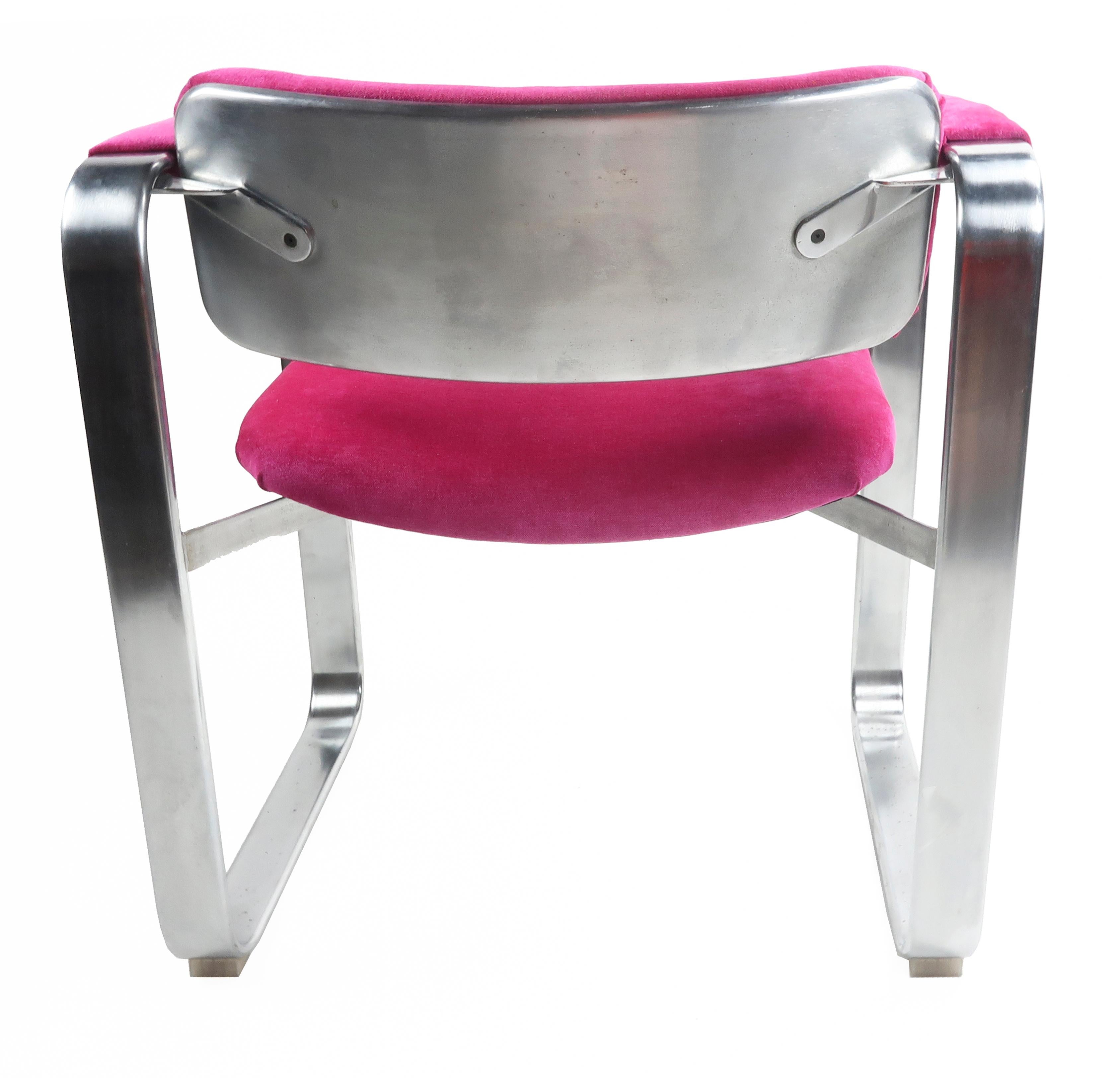 A dazzling Scandinavian Modern executive armchair by famed Finnish designer Eero Aarnio for Mobel Italia (1968). The frame has a satin chrome finish with a stainless back. and new hot pink/fuchsia chenille upholstery on the seat, back and