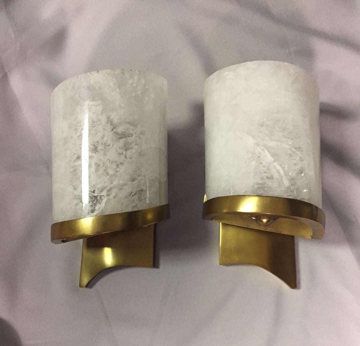 Elegant one-of-a-kind pair of Modern style hand-carved and hand polished rock crystal and brass sconces. 

Rock crystal is a semi-precious stone mined from the earth. These matchless pieces are hand-carved and hand polished from all natural