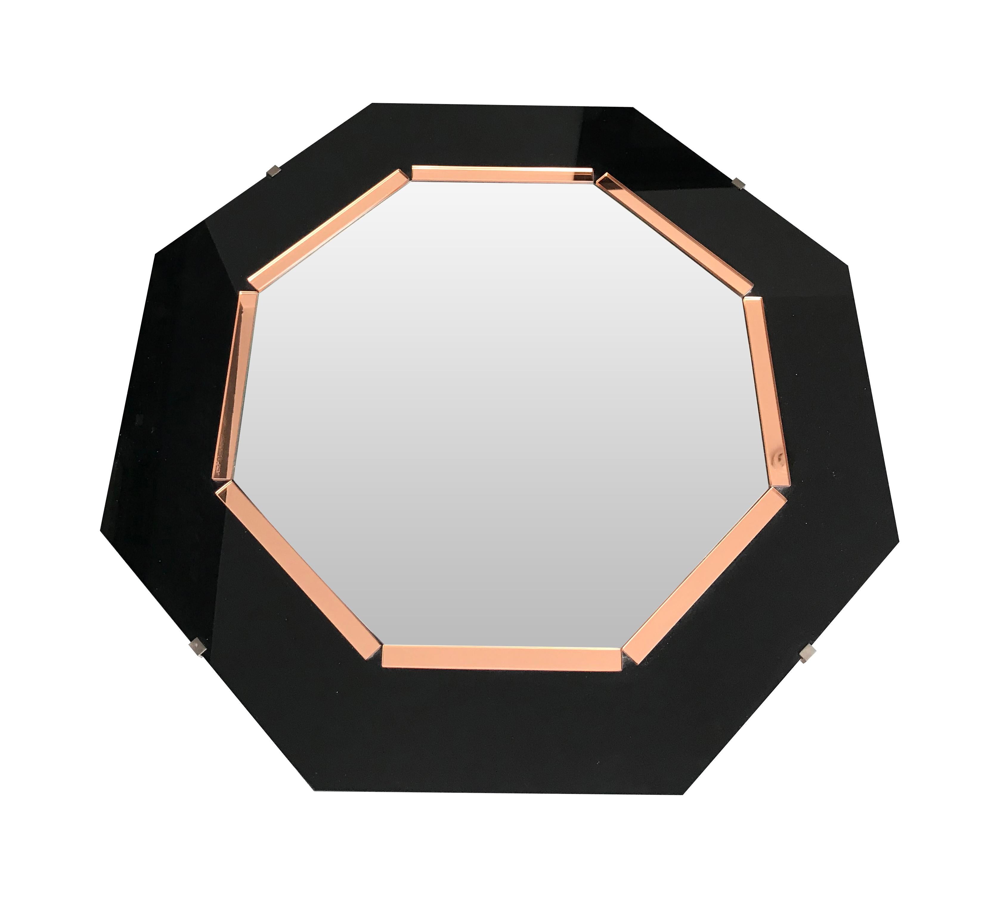 An Art Deco style octagonal mirror with black glass surround and rose mirror interior frame around a bevelled mirror and mounted on board.