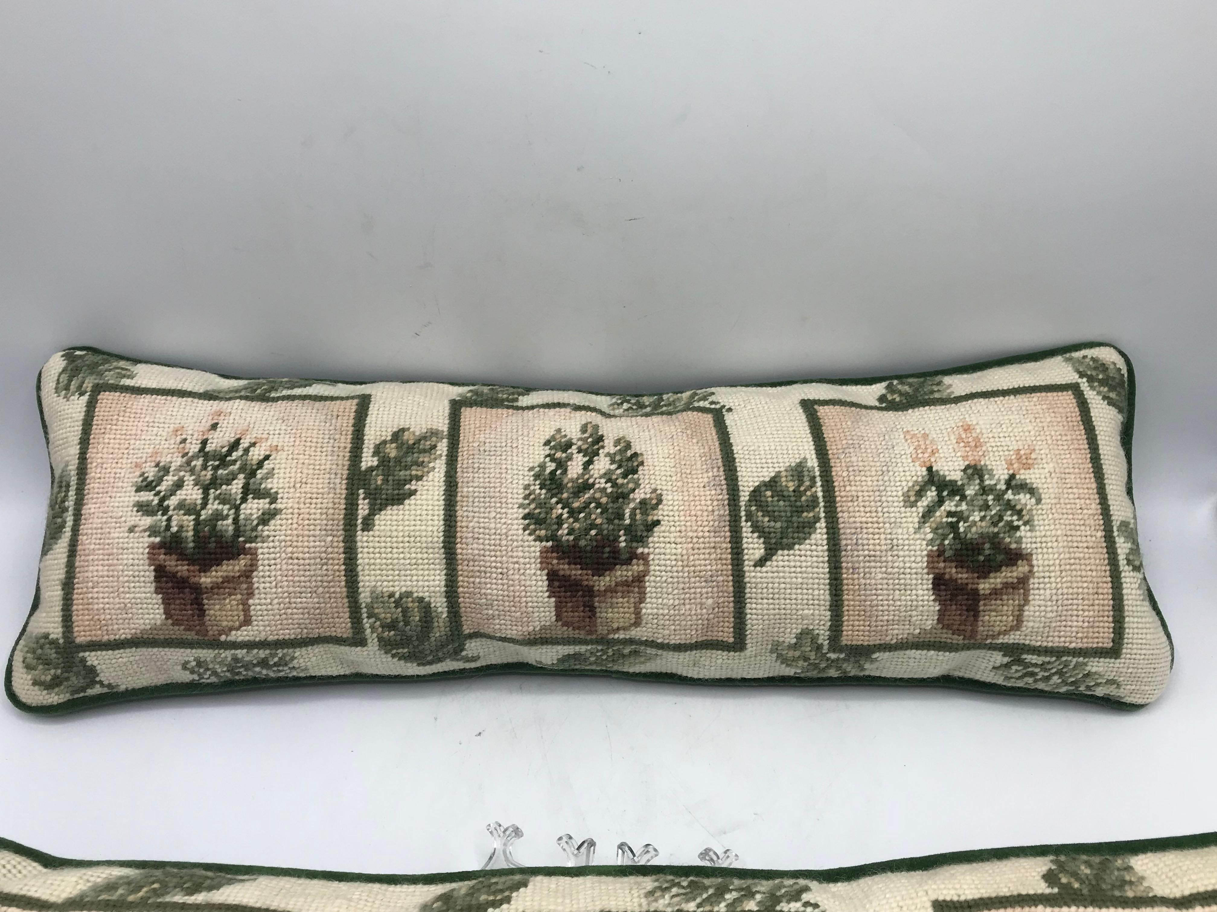 Offered is a stunning, pair of 1980s needlepoint lumbar pillows. The pair has a beautiful, identical, planted topiary motif on each. Velvet backside. Poly-fill. No zipper.