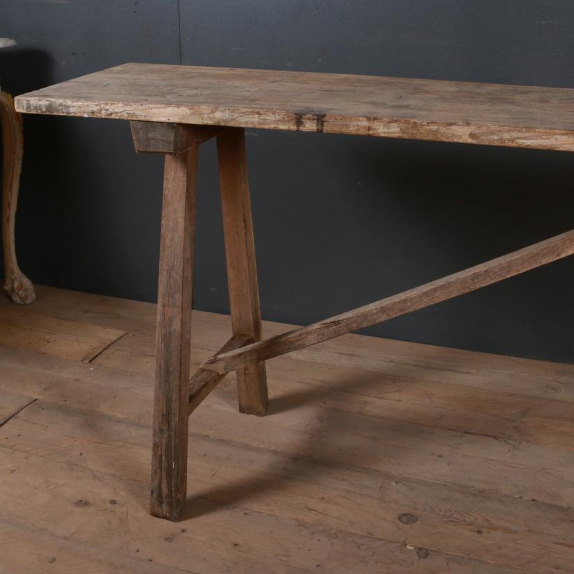 Narrow mid-19th century, French trestle table with a scrubbed oak surface, 1850.

Dimensions:
98.5 inches (250 cms) wide
16 inches (41 cms) deep
34 inches (86 cms) high.

 