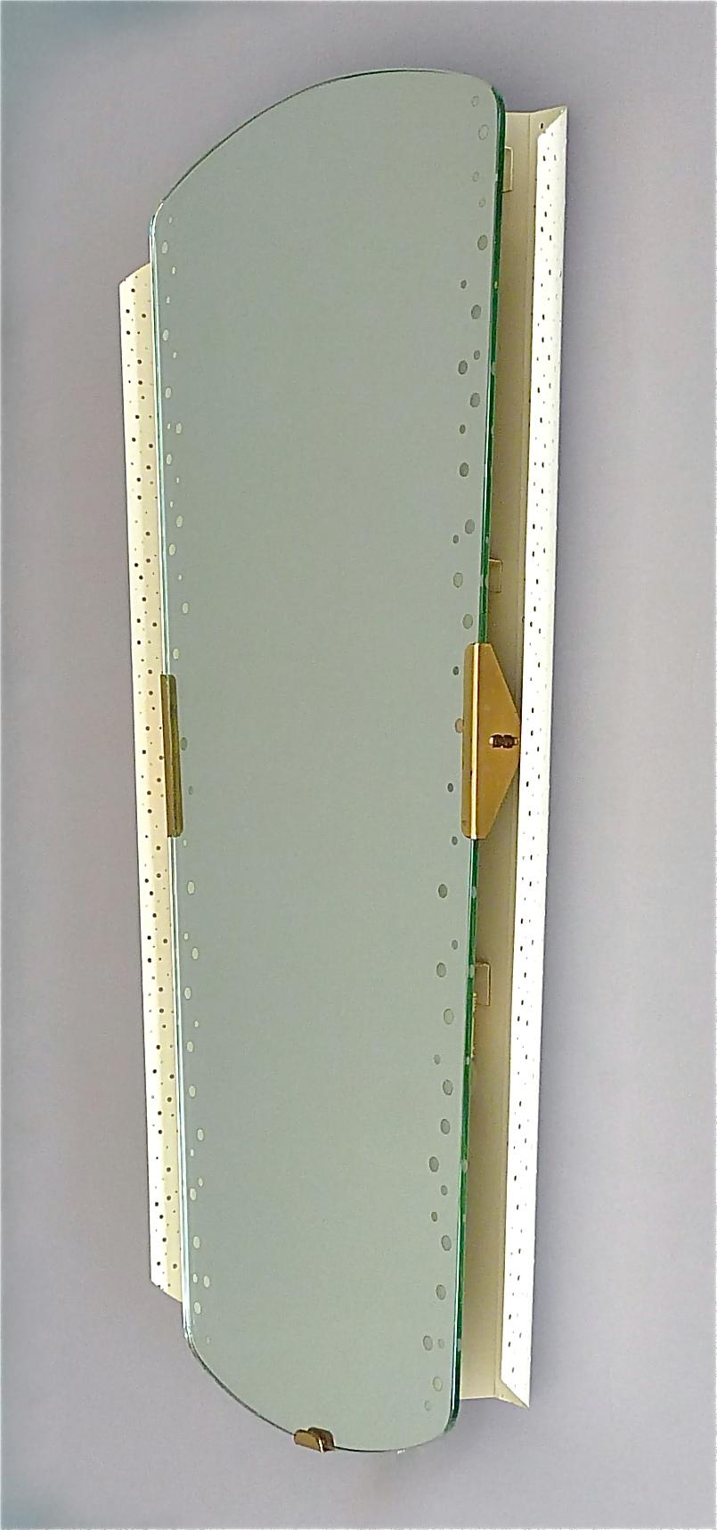 Large illuminated midcentury wall mirror designed by Ernest Igl for Hillebrand Leuchten, Germany 1950s which reminds very much the designs and the style of the french designer Mathieu Mategot or Jacques Biny. The high quality mirror has an off-white