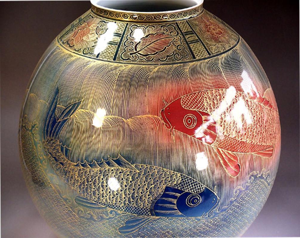 Unique extremely intricately gilded and hand-painted large contemporary decorative Porcelain vase in
brilliant red, cobalt blue and gold. Featuring the auspicious “koi fish” motif, a signed masterpiece from the signature collection by highly