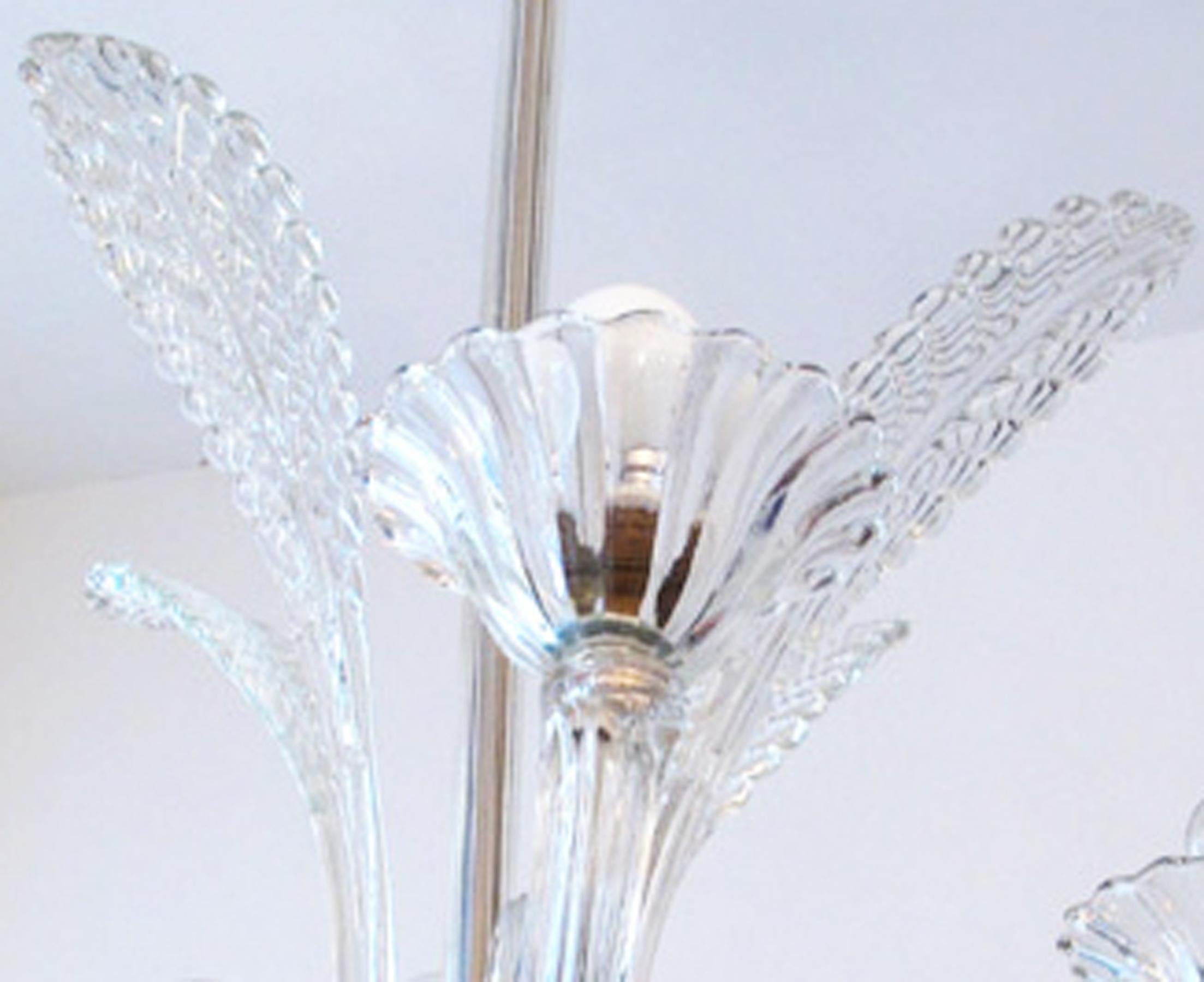 This crystal chandelier is made from Murano glass. It features four arms and four palm leaves, measuring one meter in height and 60 cm diameter. It was produced in the 1950s and is in very good vintage condition, having been rewired.