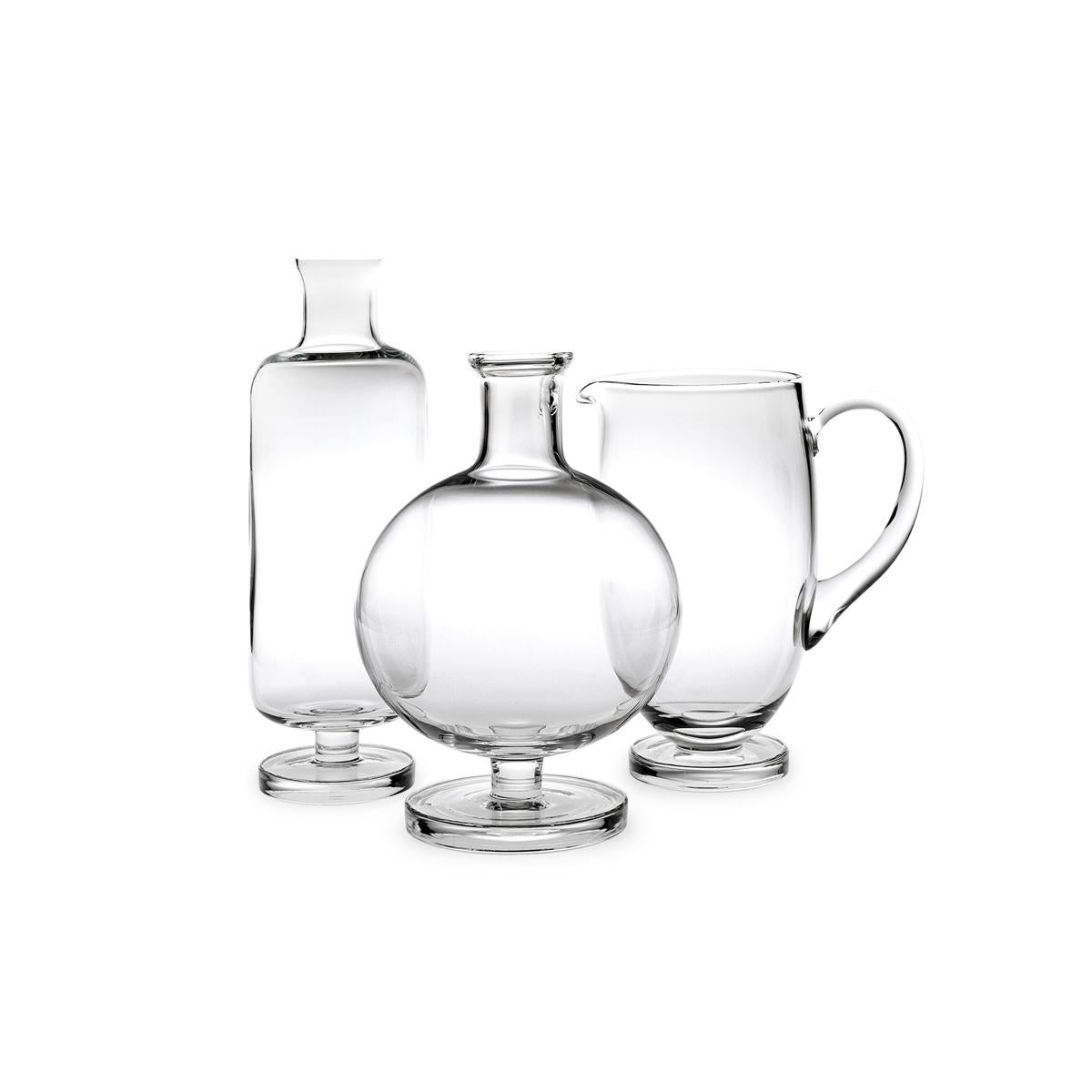 Decanter made in blown in a mold glass. The Tulip collection is a glassware family by Aldo Cibic, who designed these pieces walking the line between classical and Postmodern design. The boldly simple geometric forms of this carafe are at once
