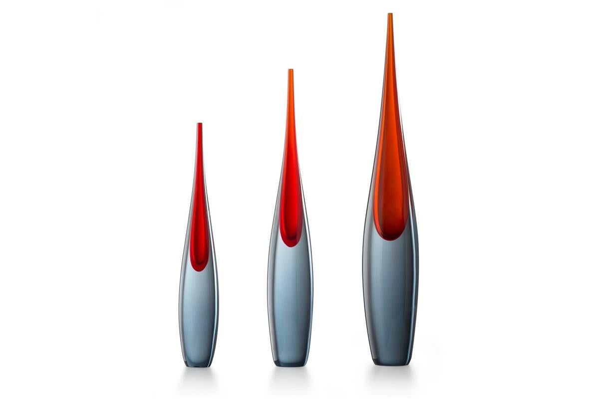 Pinnacolo in grey steel and red Murano's blown glass

The tall and slender Pinnacolo vases were designed by Luciano Gaspari and made using his favourite technique, the sommerso. The sunken blue and green glass versions were showcased at the 1960