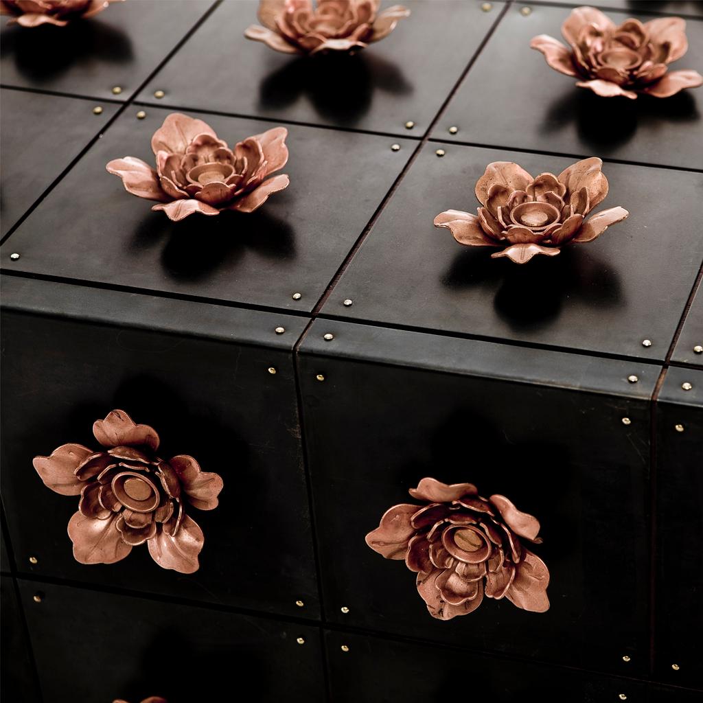 The Rosette sideboard belongs to the Rosette collection designed by Egg Designs and manufactured in South Africa.
This high end, contemporary and bespoke server is covered with a riot of copper steel flowers, these flowers surround the entire piece