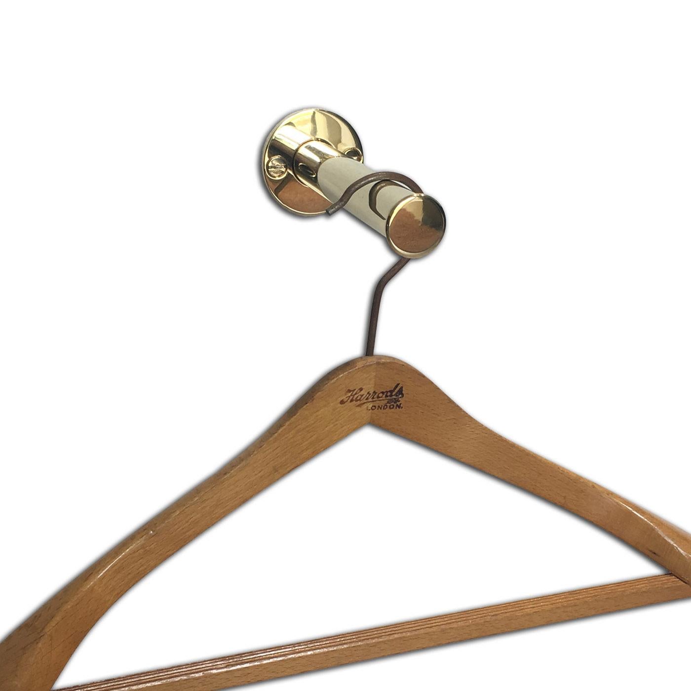 An Andrew Nebbett Designs retactable wall mounted valet hook (ideal for dressing rooms etc.) in polished brass.
The valet hook back plate is 4 cm diameter and the hook extends 15 cm out from the wall.
This valet hook is made to order and is