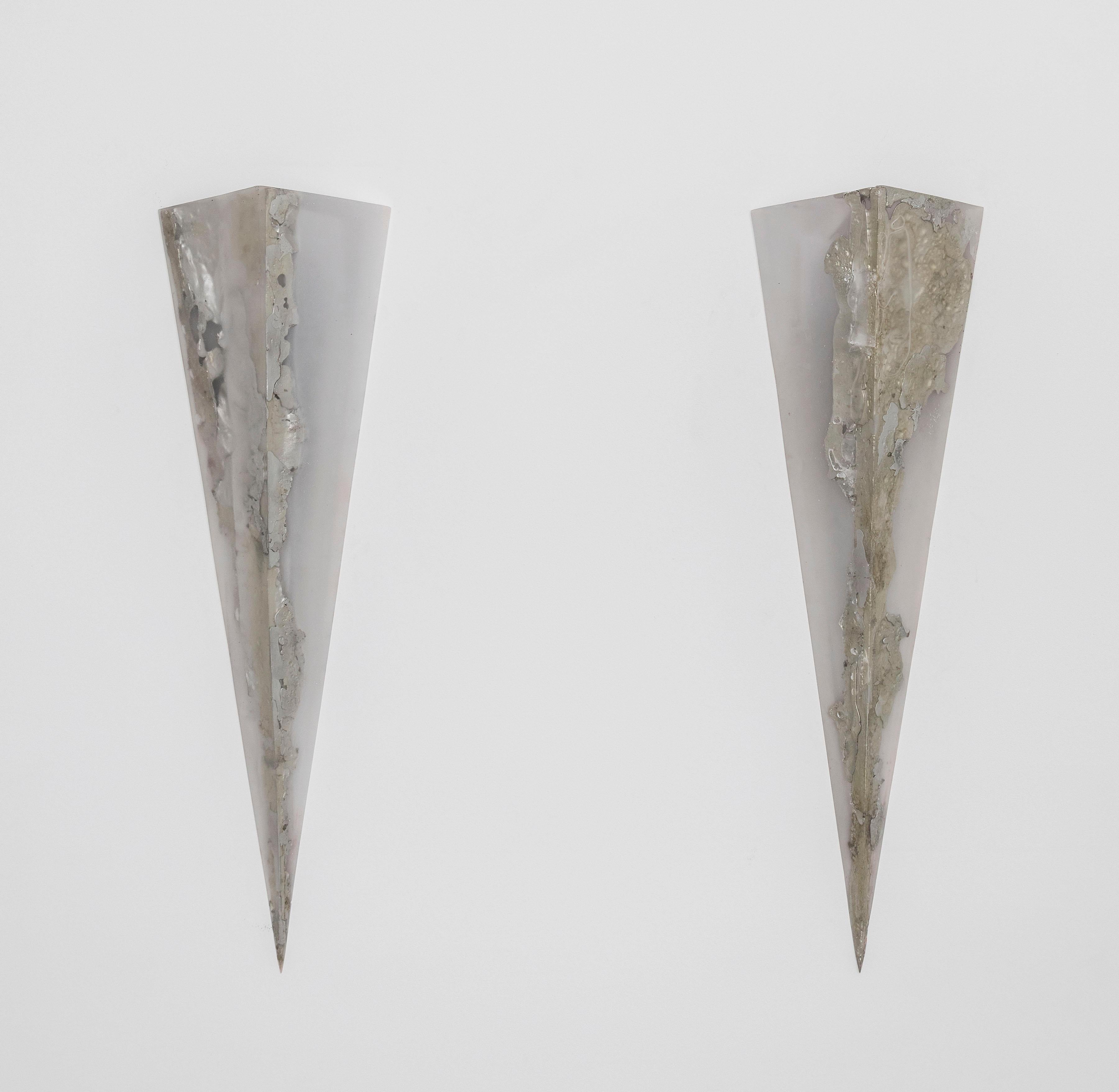 Cast in clear resin and melted pewter, these sconces are made by hand and customizable upon request.
