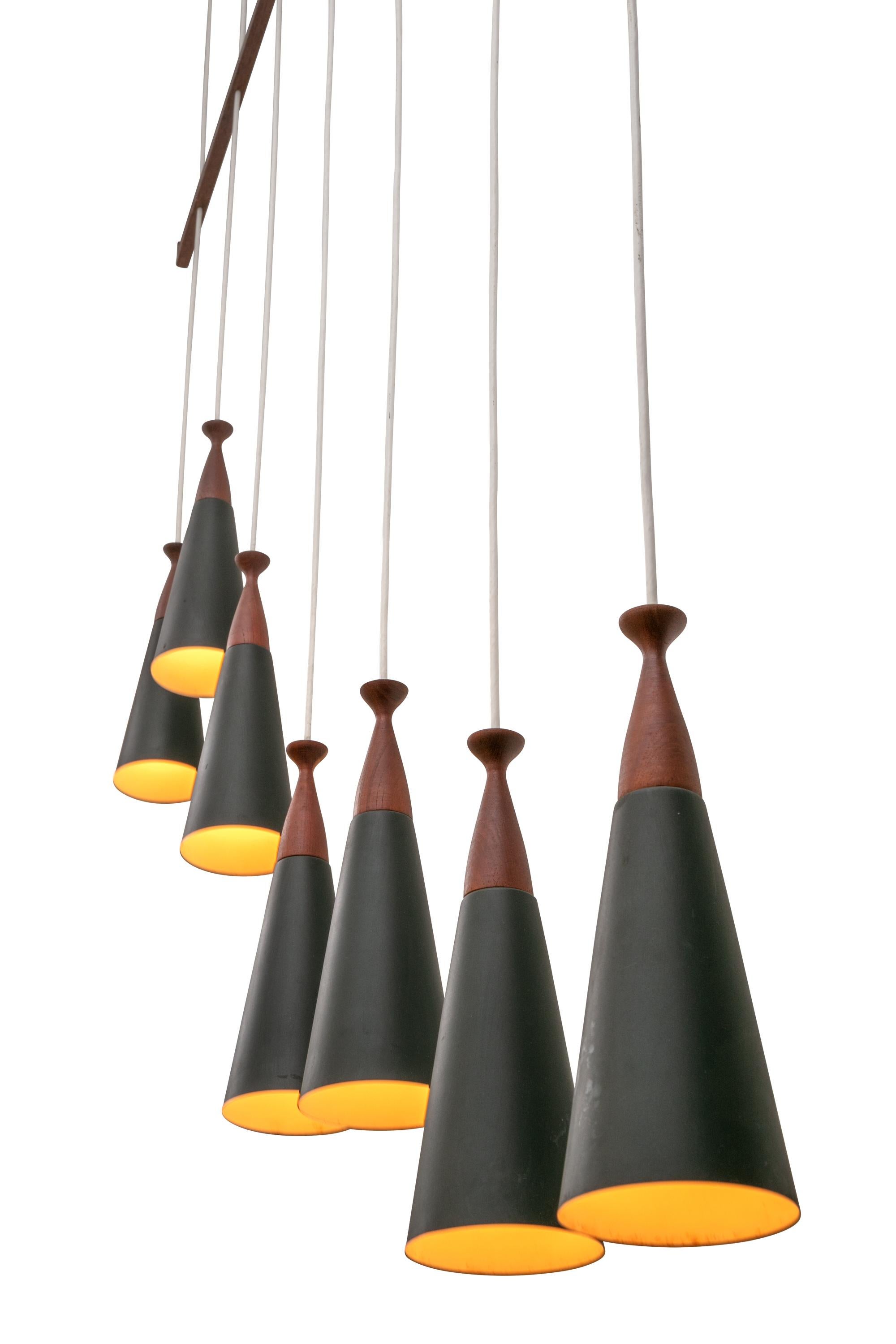 Impressive in it's scale and teak elements. The individual pendants could be adjusted in height if desired.