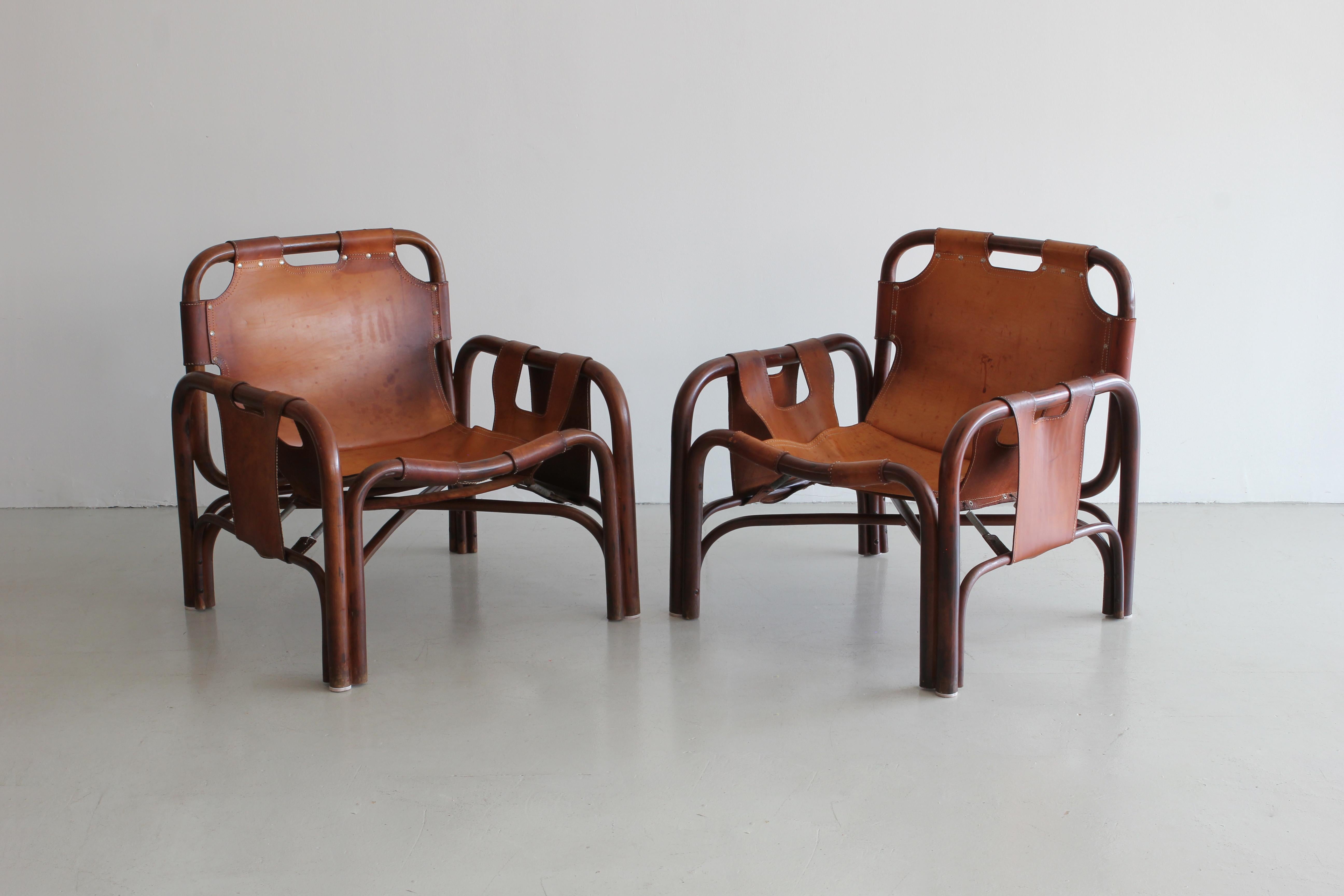 Leather sling chairs in the style of Charlotte Perriand with bentwood frames, leather and rivets. 
Wonderful patina to leather.
 