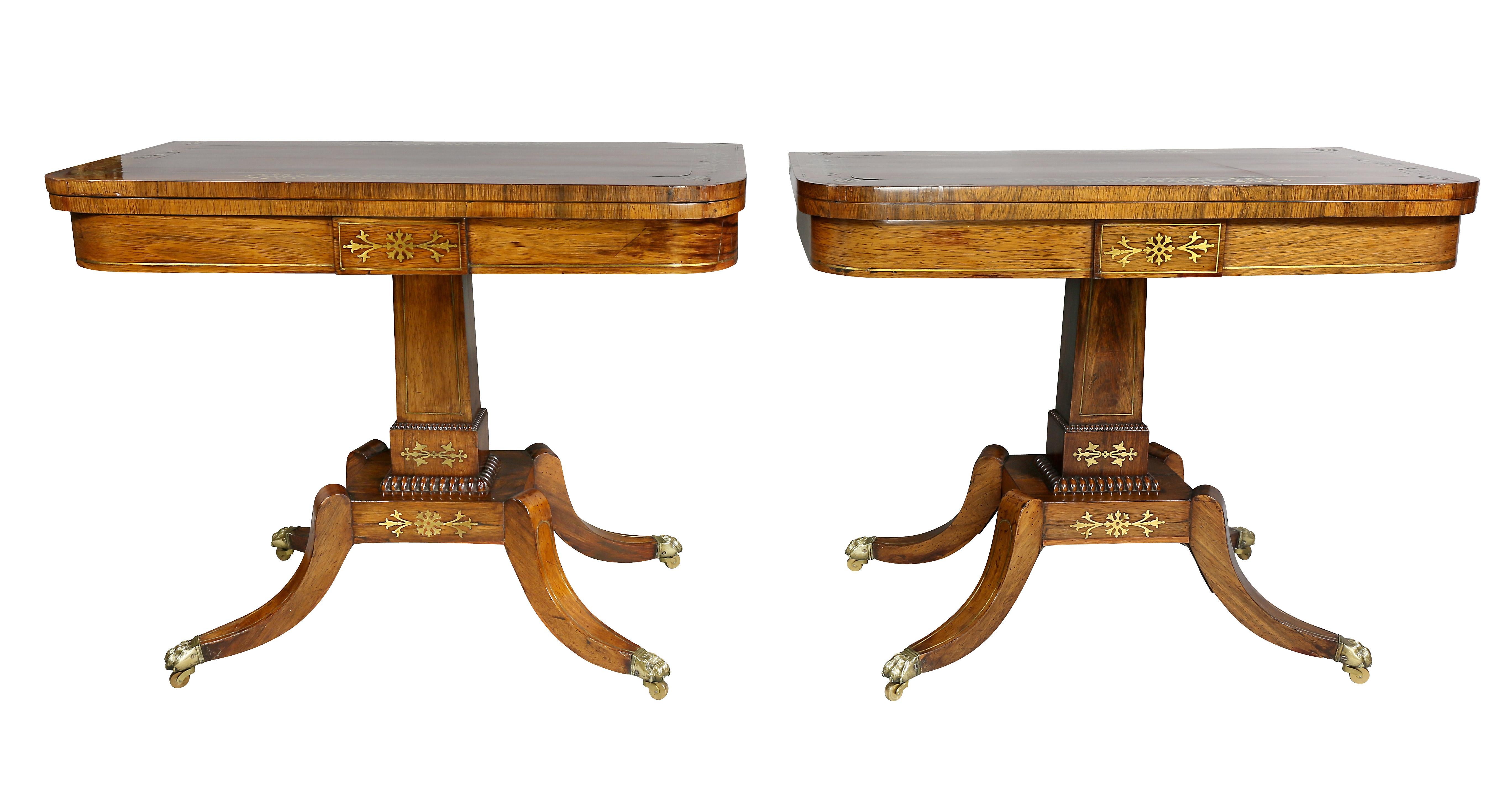 Each with rectangular hinged tops with brass inlaid outer borders, felt lined playing surface raised on a square form supports, beaded carving and four saber legs with brass inlay ending on casters.