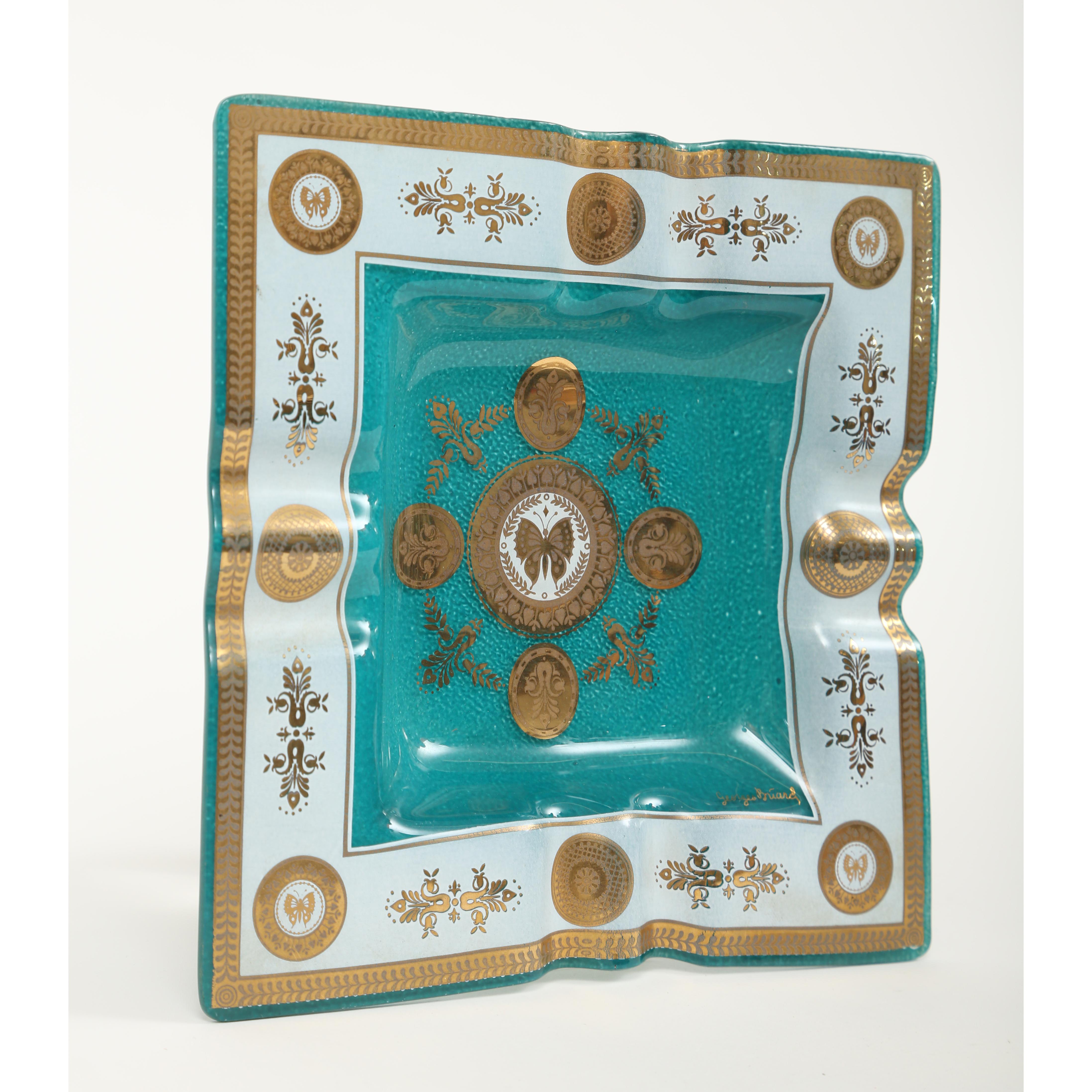 Georges Briard square tray in the embassy pattern. The color is actually an emerald green with white and 22-karat gold decoration. The wide border has a laurel wreath pattern and gold medallions of butterflies. The butterfly motif appears again in