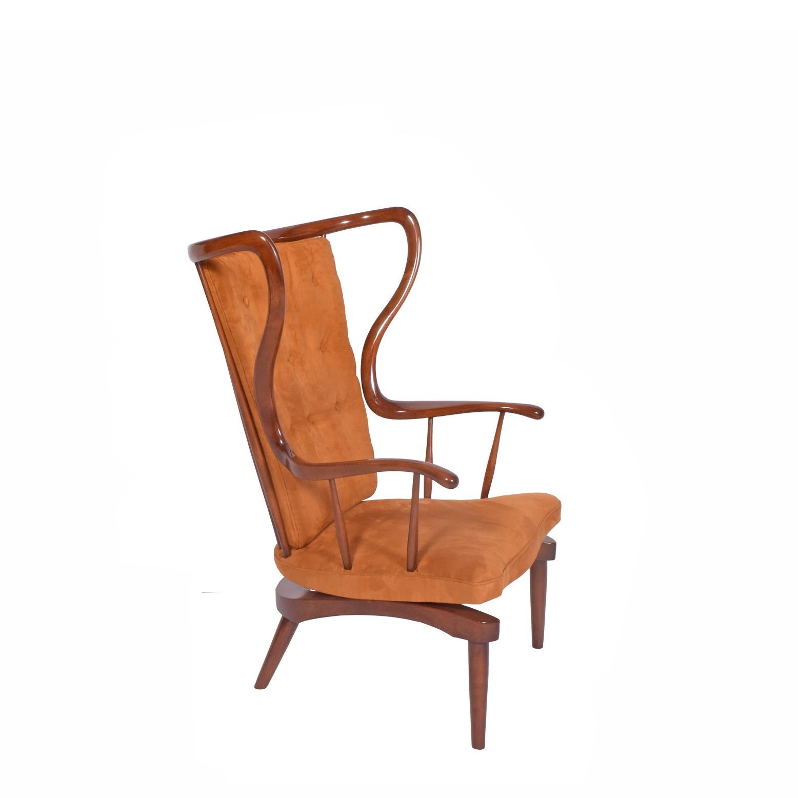 Sculptural, mid-20th century, walnut-stained beechwood Danish rocking chair with slightly elevated seat and two spring rocking mechanisms underneath. Seat and back cushions reuphulstered in faux ultra suede. Loose-back cushion.