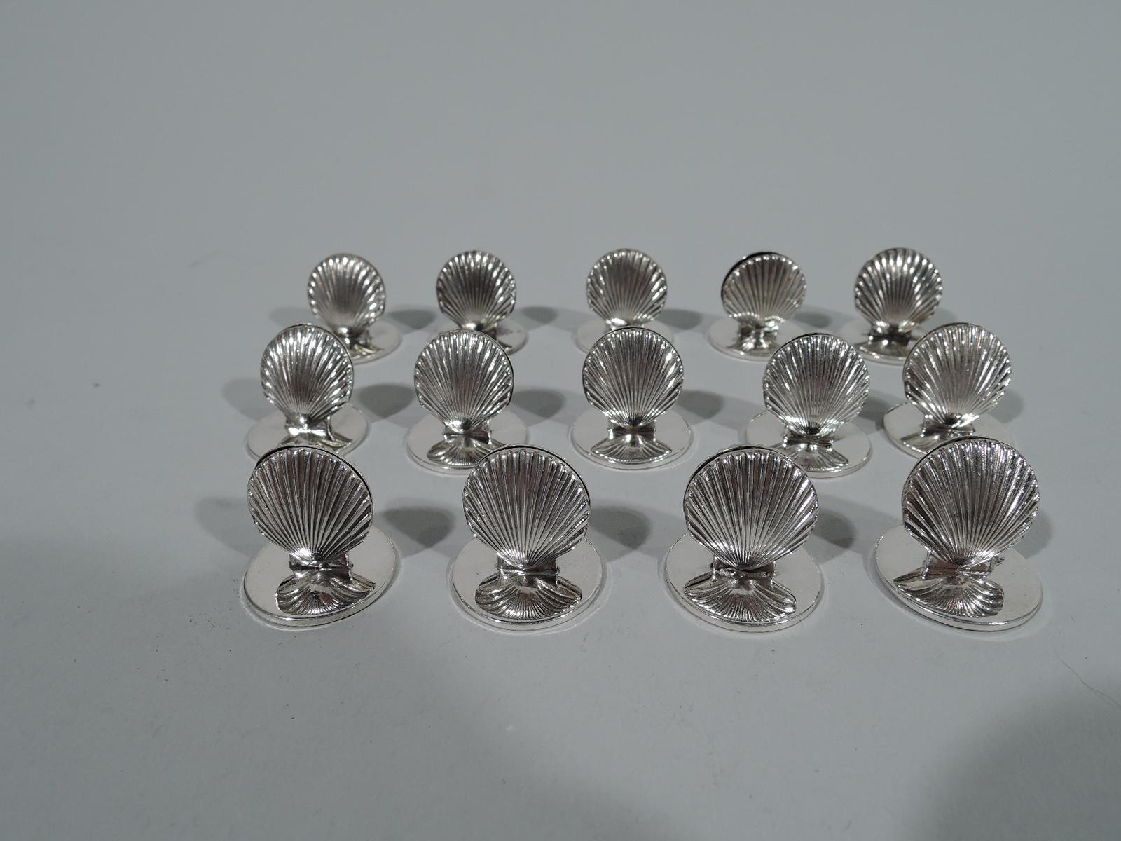 Set of 14 modern classical sterling silver place card holders. Made by Tiffany & Co. in New York, circa 1965. Each: Double-sided scallop shell mounted to flat circular base. Hallmarked. Total weight: 4.3 troy ounces.
