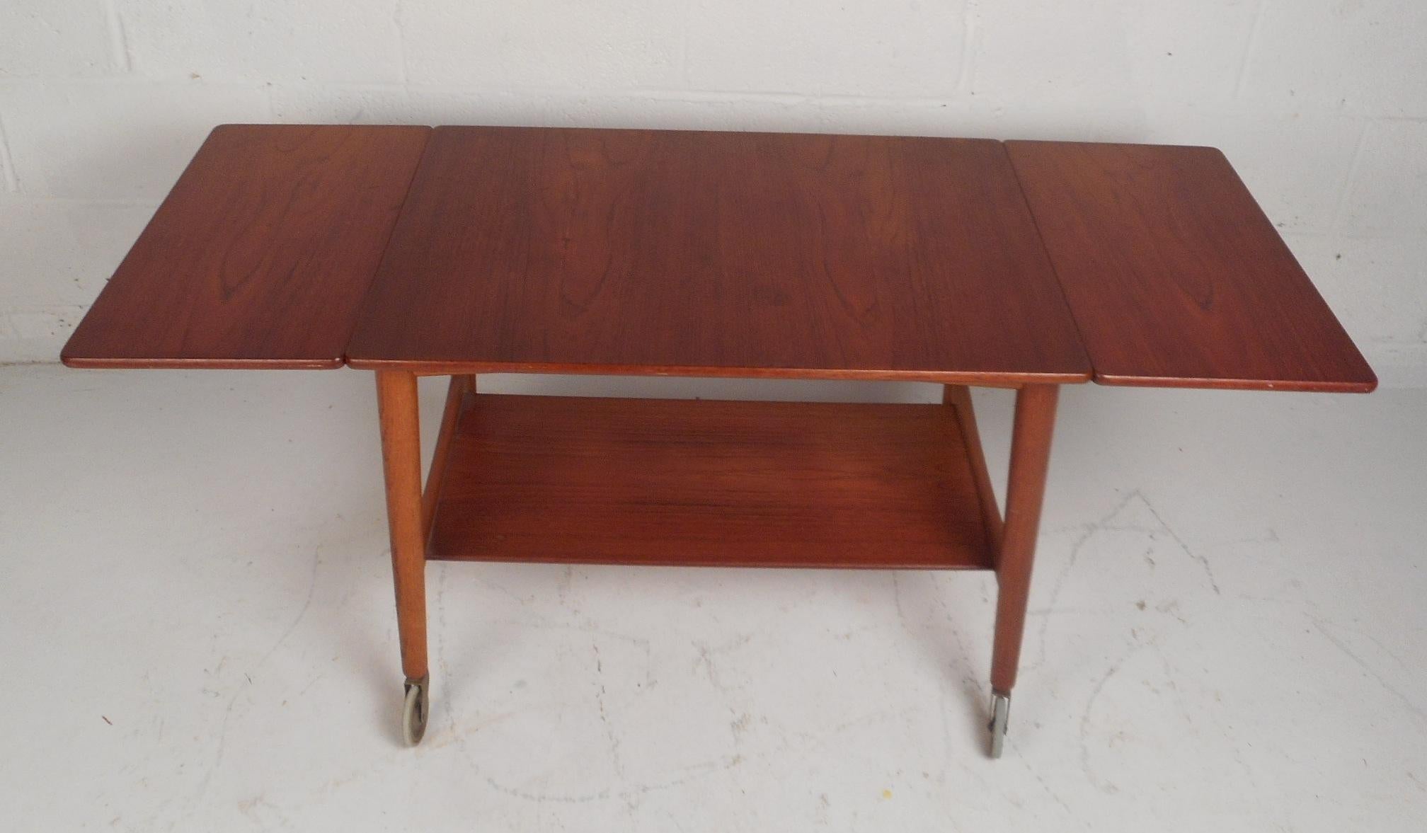 This beautiful vintage modern drop-leaf side table is stamped, 
