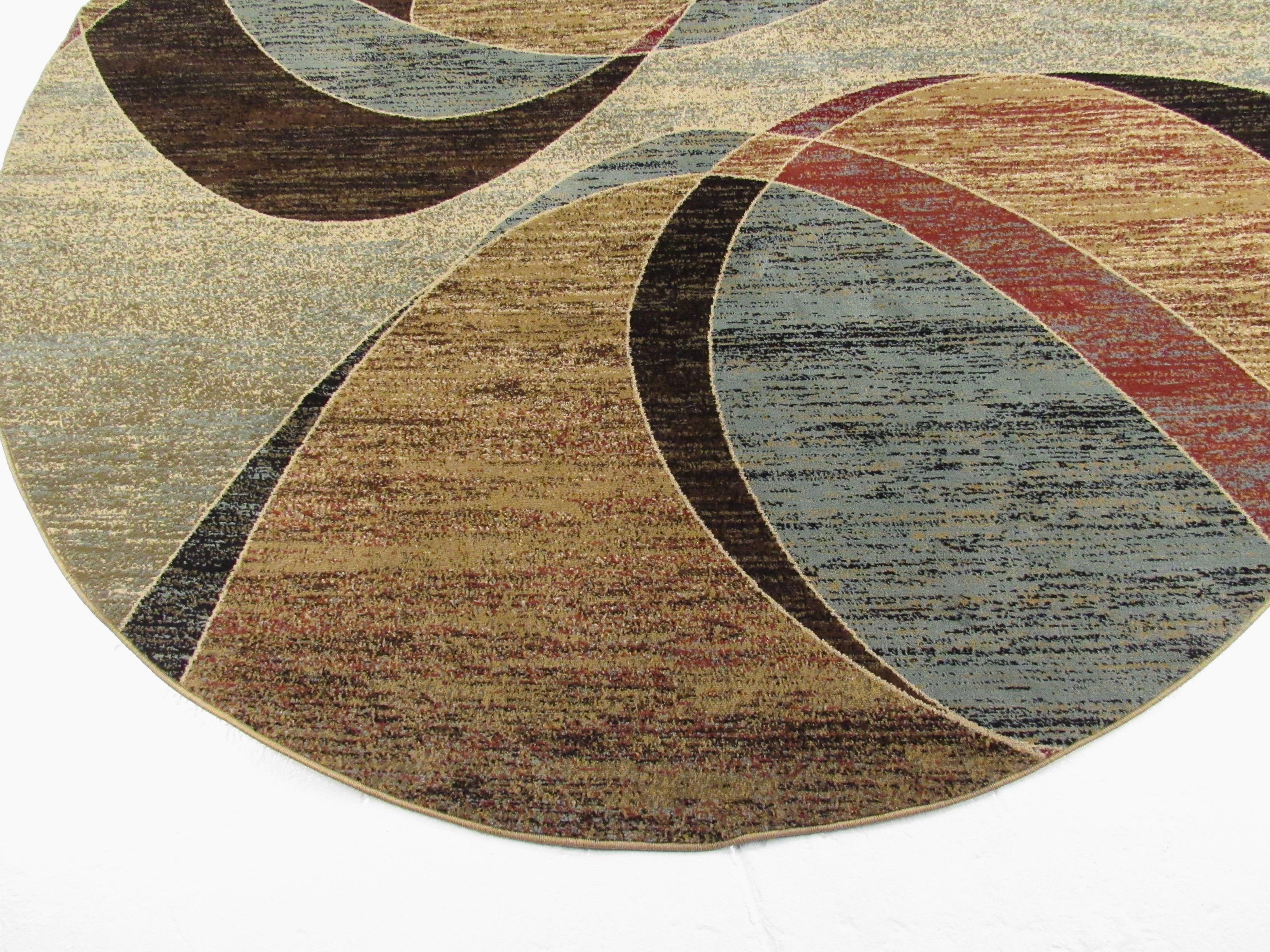 This modern circular area rug features a mixed palette of colors and makes a subdued yet impressive addition to home or business interior. Please confirm item location (NY or NJ).