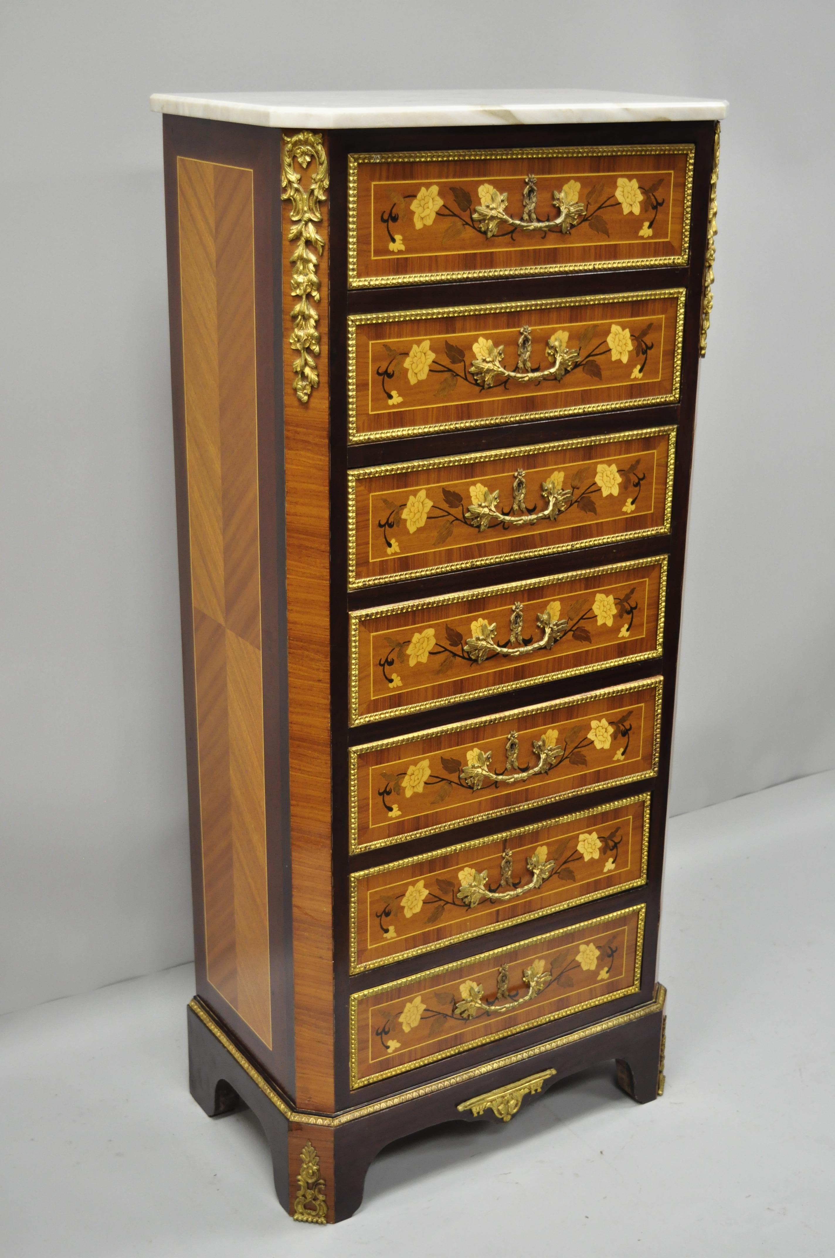 Marble-top inlaid seven-drawer lingerie tall chest. Item features white marble top, satinwood floral inlay, brass floral ormolu, working lock and key, seven dovetailed drawers, and great style and form. circa late 20th century. Measurements: 55.25